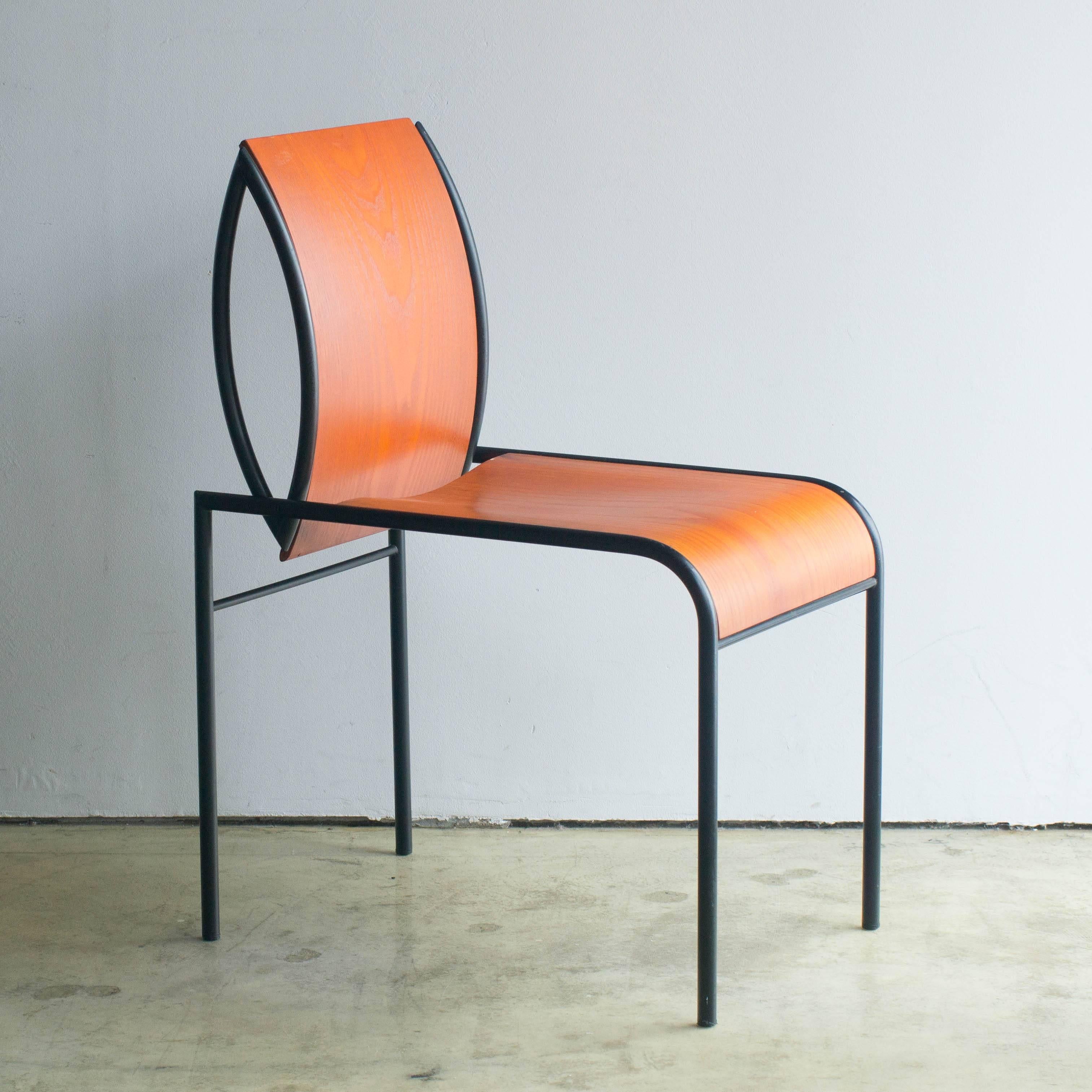 Kim chair designed by Michele De Lucchi in 1987. Made of unique shaped black steel frame and bent plywood for back and seat. Memphis logo mark is on the back of the seat. This logo is printed directly to the wood. So, I suppose it was made in the