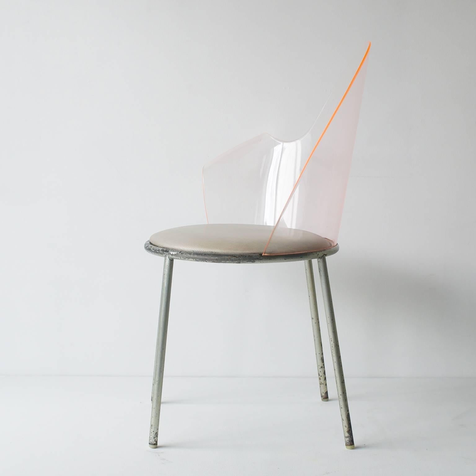 Acrylic back chair commissioned model for yamagiwa showroom. The whole space of Yamagiwa showroom interior designed by Shiro Kuramata in 1983. This chair was produced only 15 to 20 chairs. Orange acrylic back, silver painted legs with plastic or