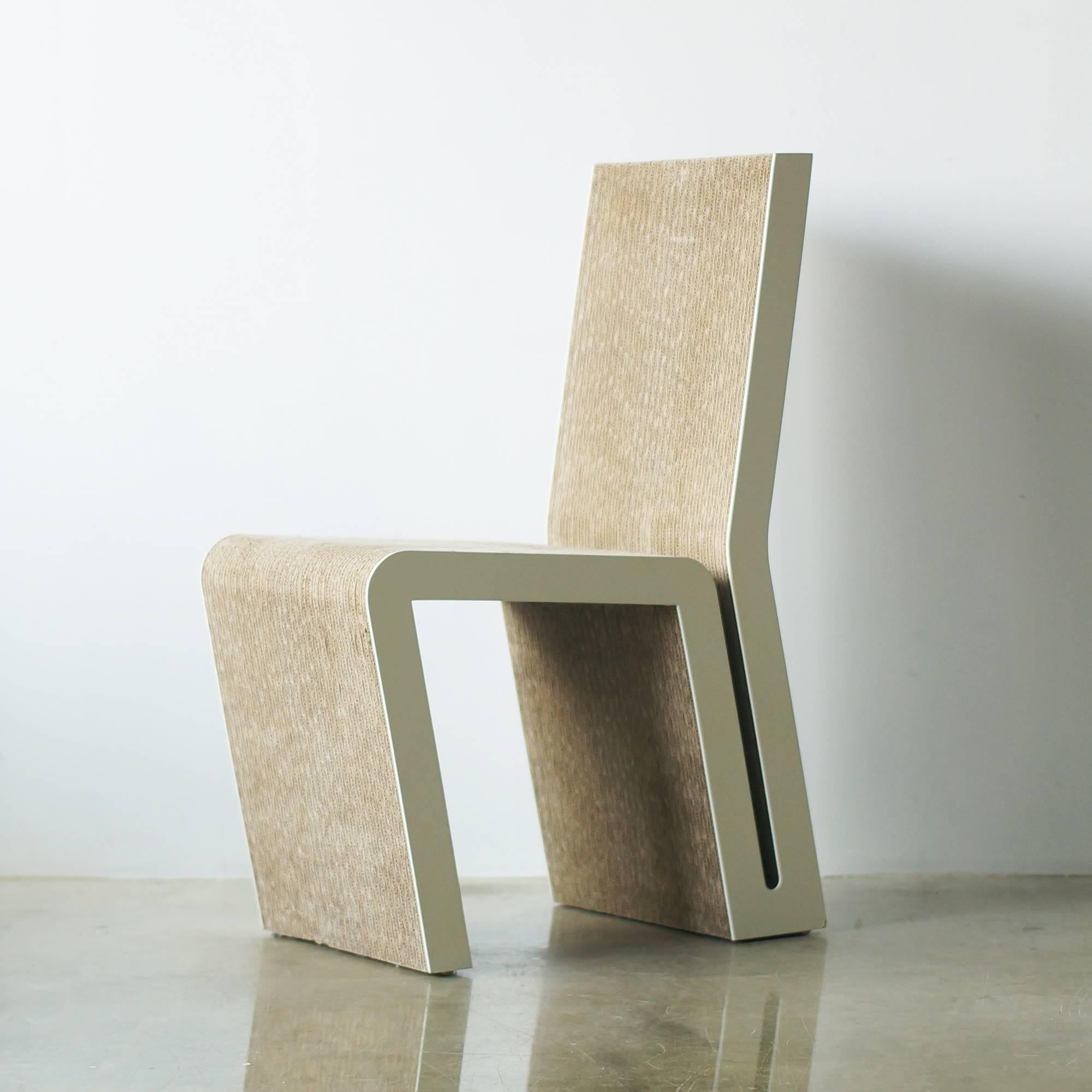 Frank Gehry's side chair for Vitra. 
This is the model that has guard on both sides of cardboard body.