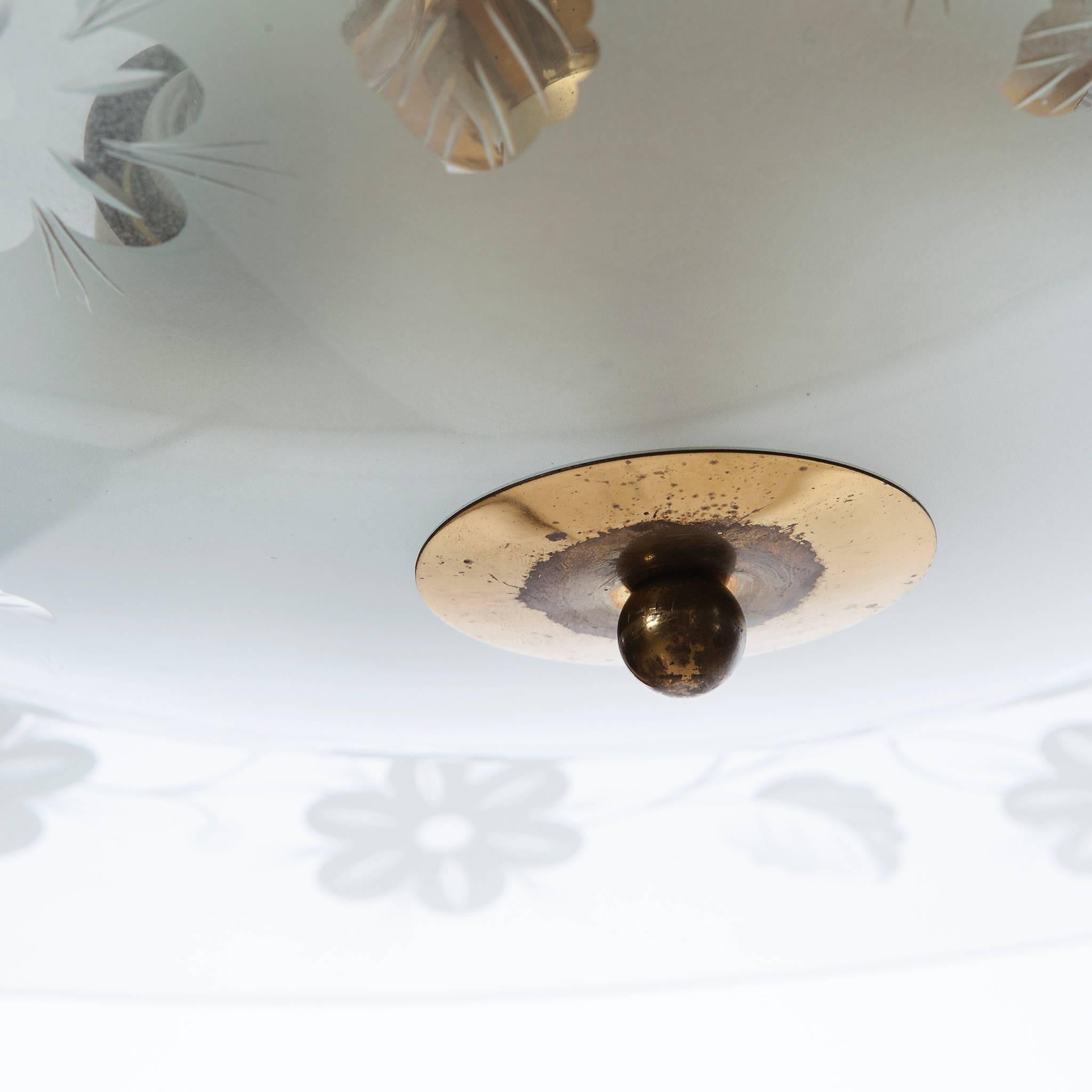 This elegant light consisting of a brass frame with 2 unique glass reflector/saucers. 
The lower round curved glass reflector with floral patterns mounts below a larger round etched & clear glass reflector. A beautiful, brass ring to connect the