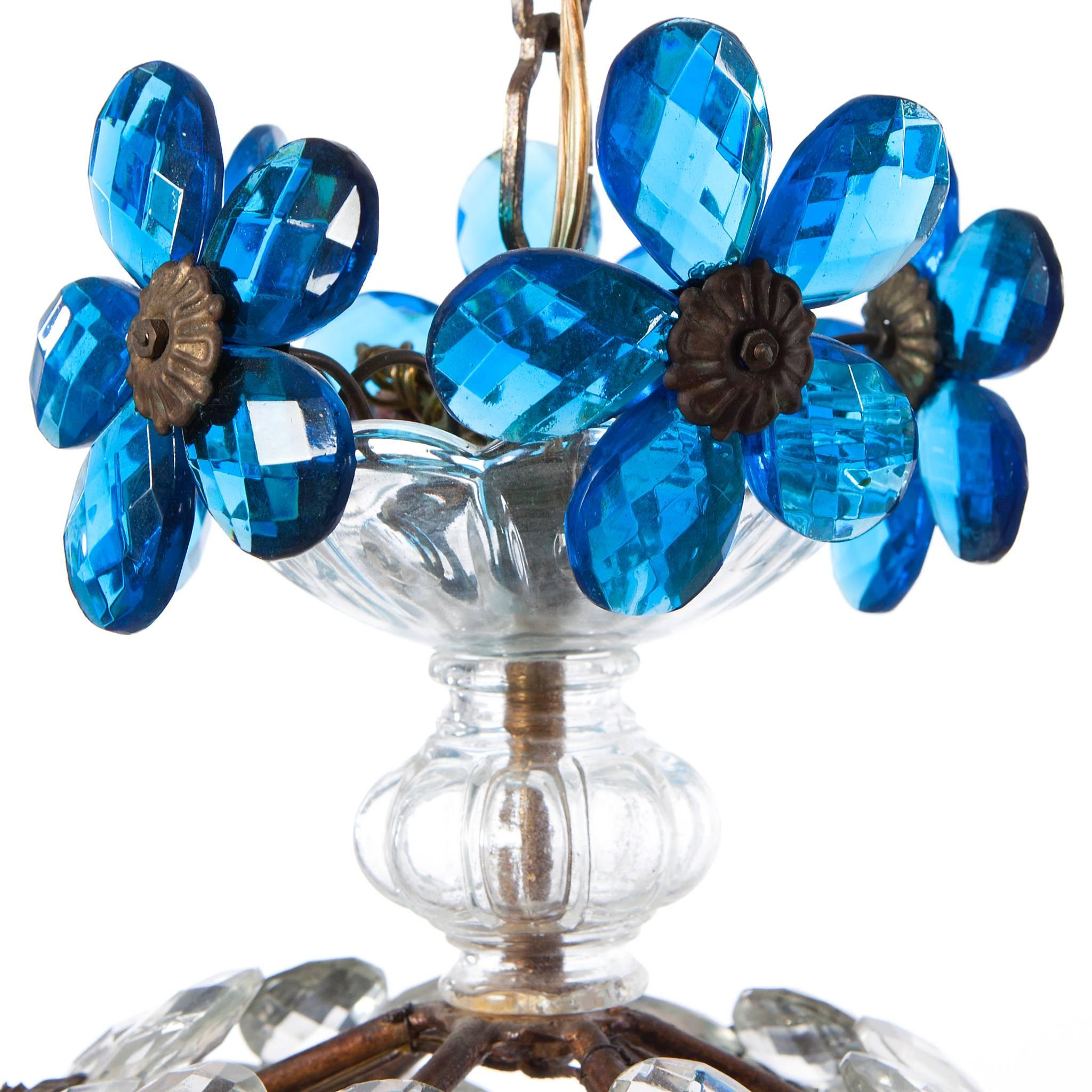 Charming gilt metal lantern with bright blue colored crystal petals creating a flower. It holds three E27 sockets. 
We also have a similar fixture with amber colored petals. code 320d