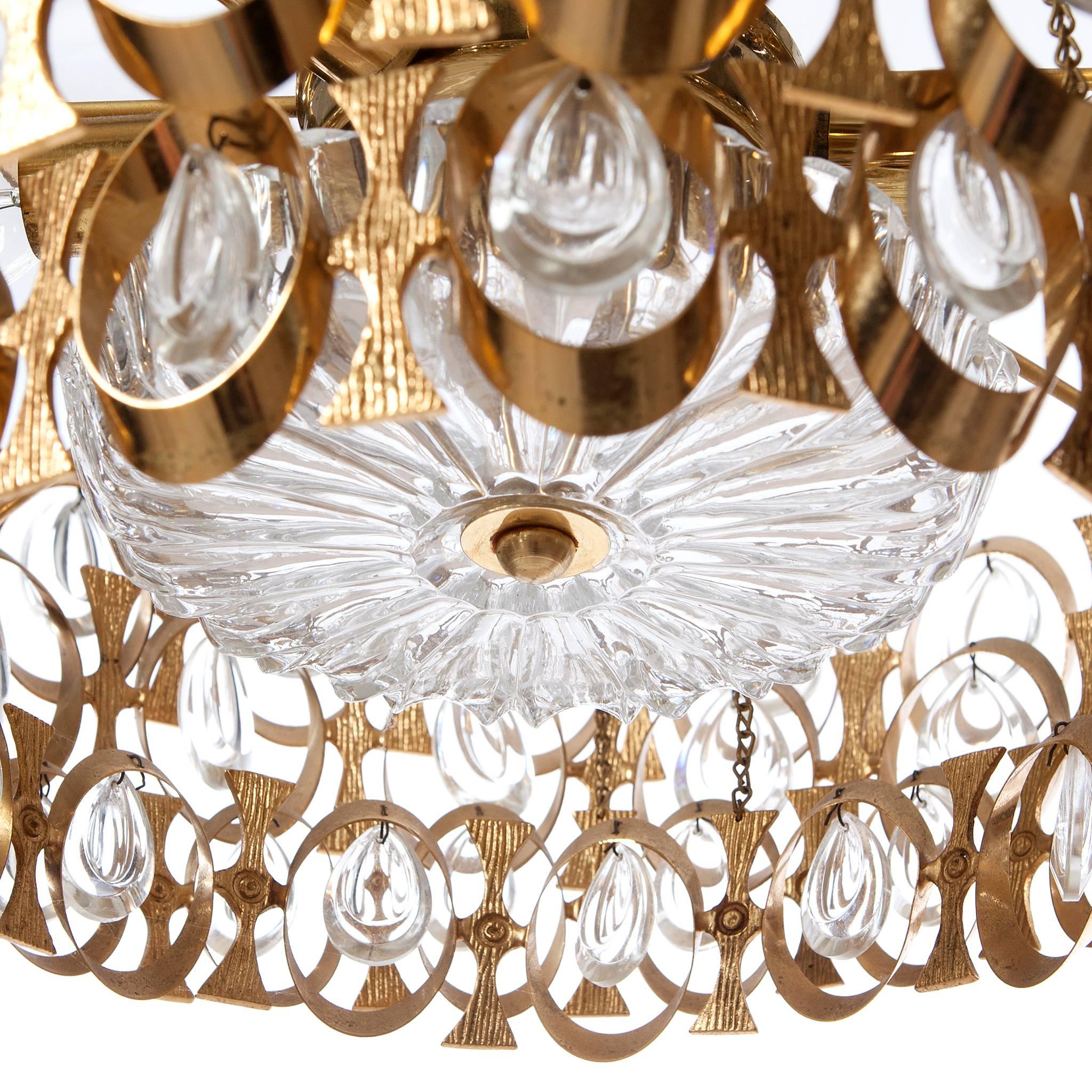 Unique eight-light Palwa, circa 1960's, chandelier with gilt brass beautifully shaped rings and plates. Its truly amazing with all it's crystal prisms excellent condition. Please note we have several chandelier in similar style and sizes.