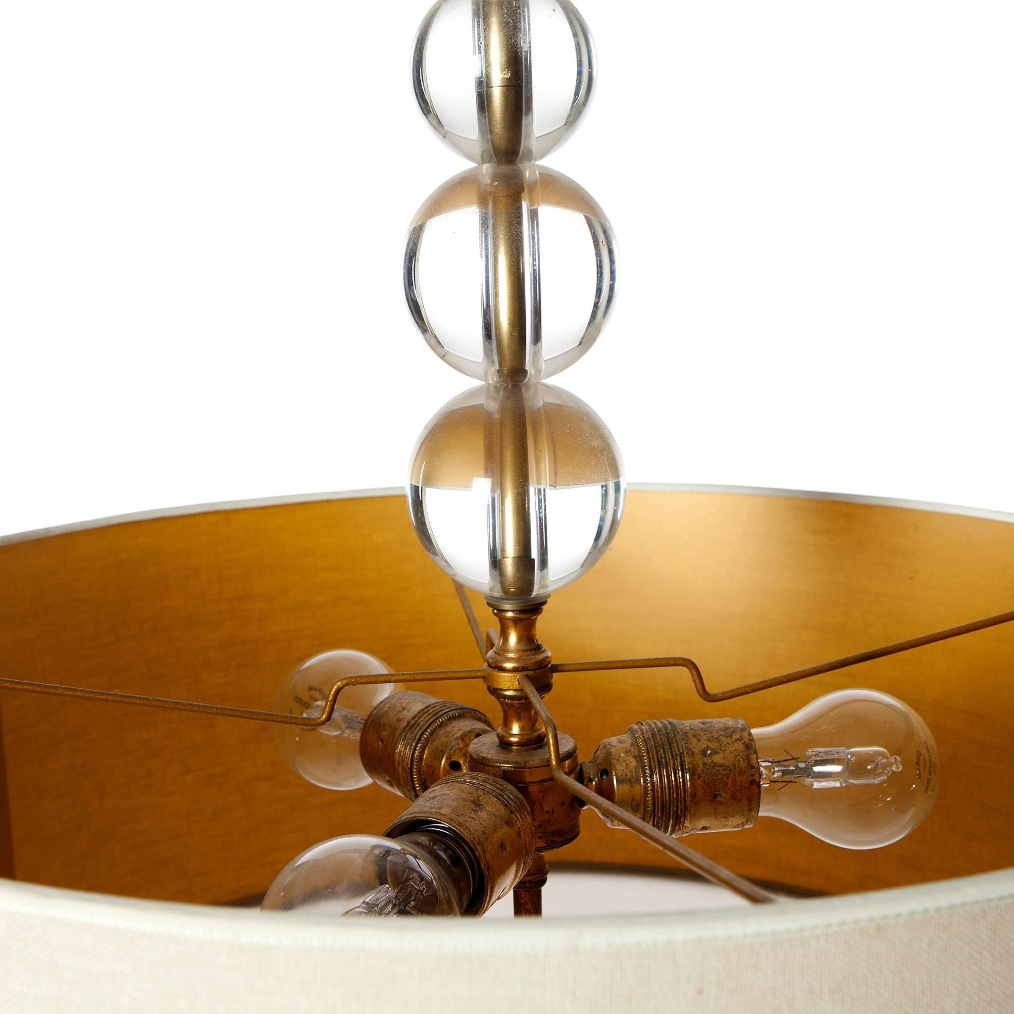 Extremely elegant three-light pendant Attributed to Jacques Adnet. On top of the cotton lampshade there are three solid polished crystal balls. For the perfect light the bottom of the lamp is filled with a plastic disk and finished with another