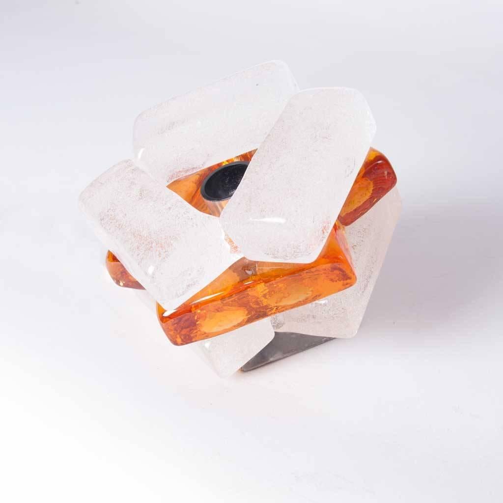 White and amber color glass cube table lamp in style of Poliarte, Italy. Placed in a corner the slanting position of the light makes it reflect beautifully on nearby walls.
