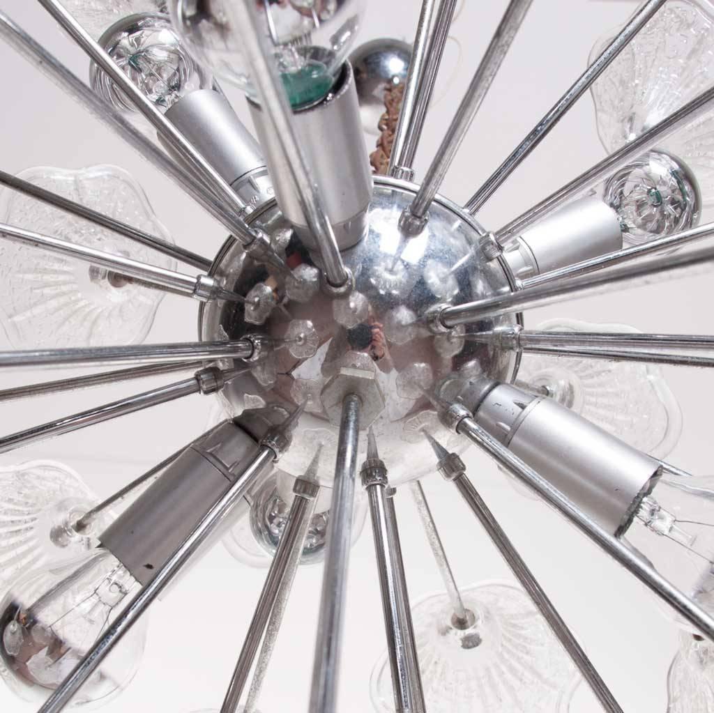 A large Italian Murano Sputnik with hand blown Murano glass flowers connected to a chrome planet with chrome plated arms. With a diameter of 60cm, this light fixture is a fashion statement on it's own. The lamp can be extended with the chrome plated