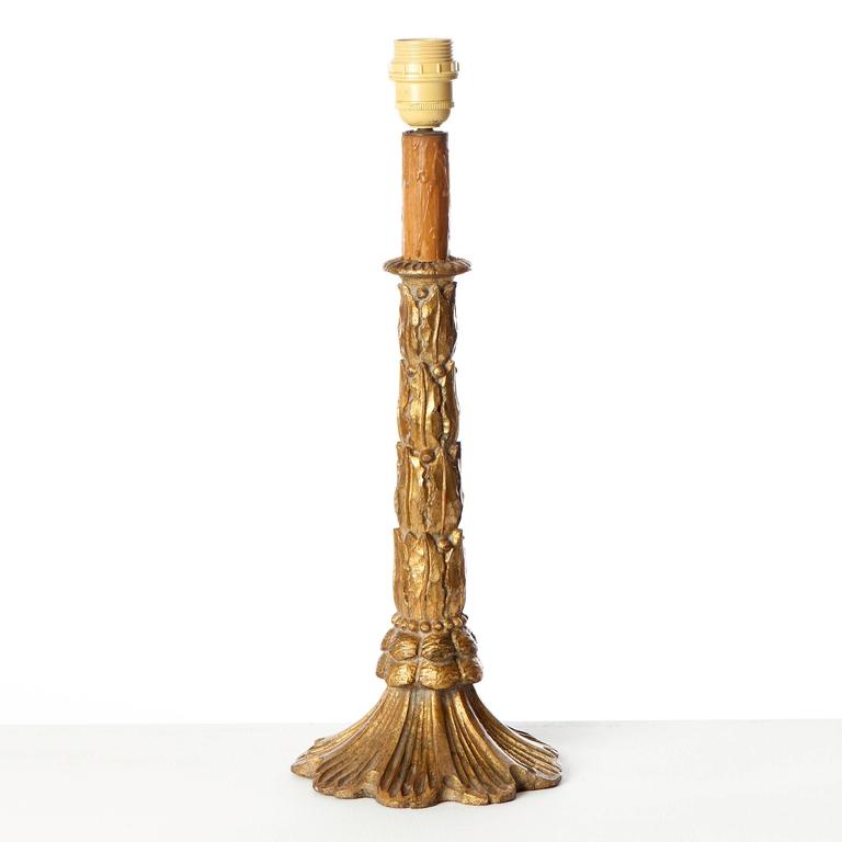 A finely carved candlestick table lamp.