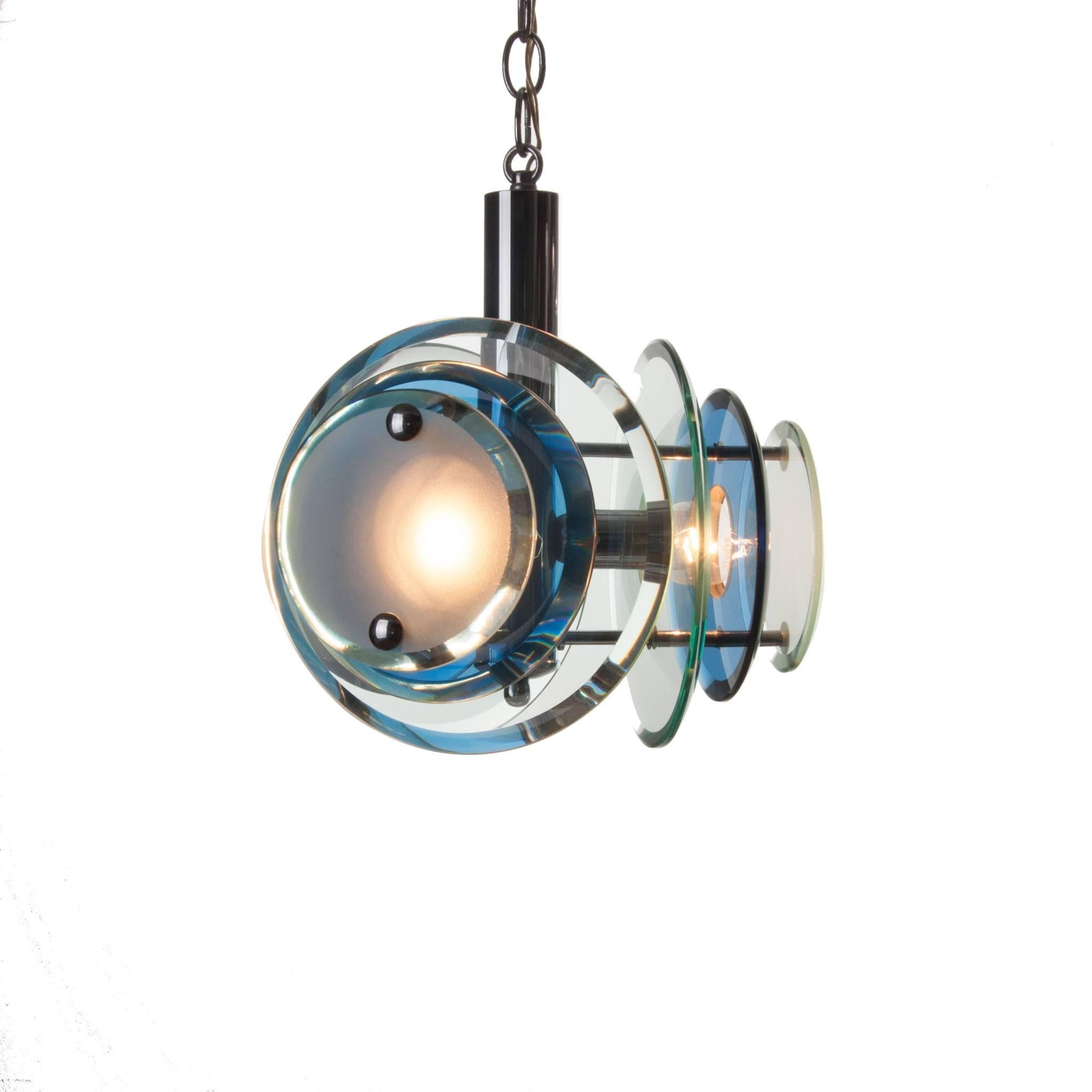 Marvellous three-light pendant.
Three arms attached to the chrome centre with on each arm one large neutral-color round transparent cut-glass, one blue-colored transparent cut-glass and one neutral small matte glass plate.
Manufactured circa 1970s