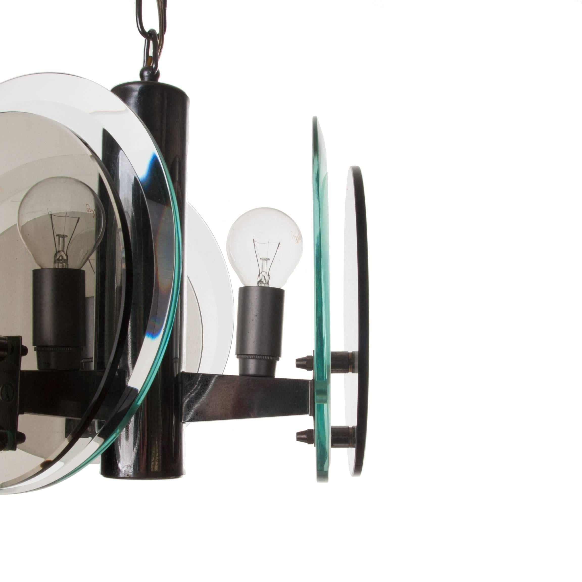 Majestic three-light pendant consist of three-arms attached to the chrome centre with two glass plates attached at each end. One larger than the other, the large circular glass plate is natural-collored transparent and the small glass plate is