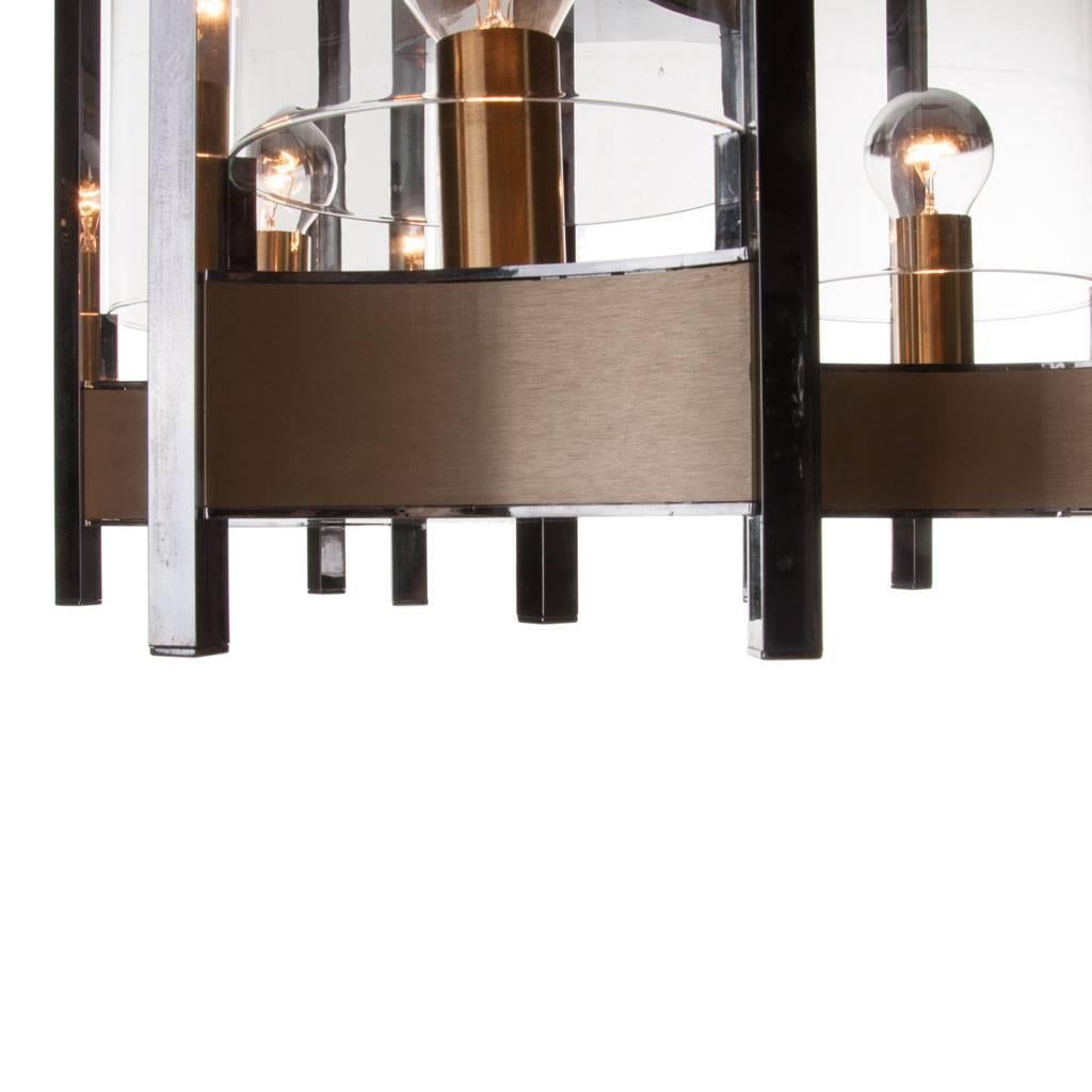 Stylish monumental Sciolari chandelier. Consist of three arms with glass cylinders on a chrome and brushed brass base.
Please note, we have different sizes chandeliers, scones and table lamps from this series.