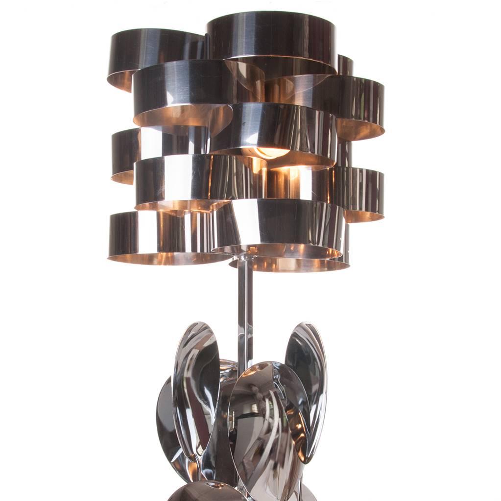 Characteristic playful large table lamp. Consist of six leaves and five layers of rings, each layer has three-chrome rings attached. It holds three lights.