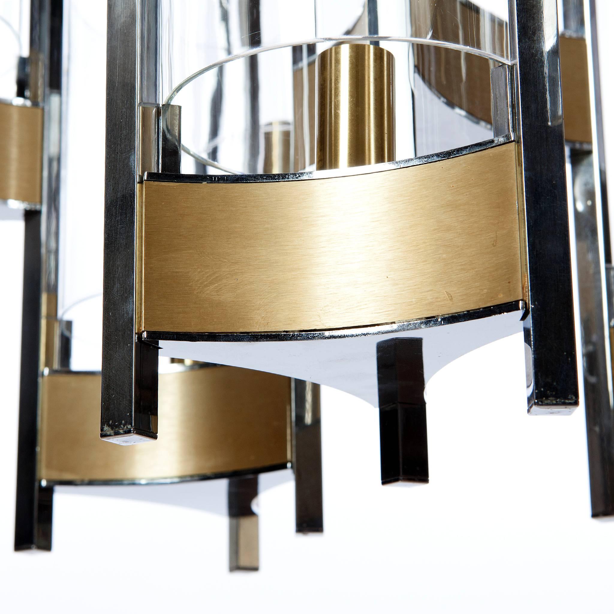 Gaetano Sciolari monumental chrome and brushed brass two-tier nine-light chandelier with cylindrical glass shades, 1960s.
Please note, we have sconces in the same style. Please do not hesitate to ask for more information. 