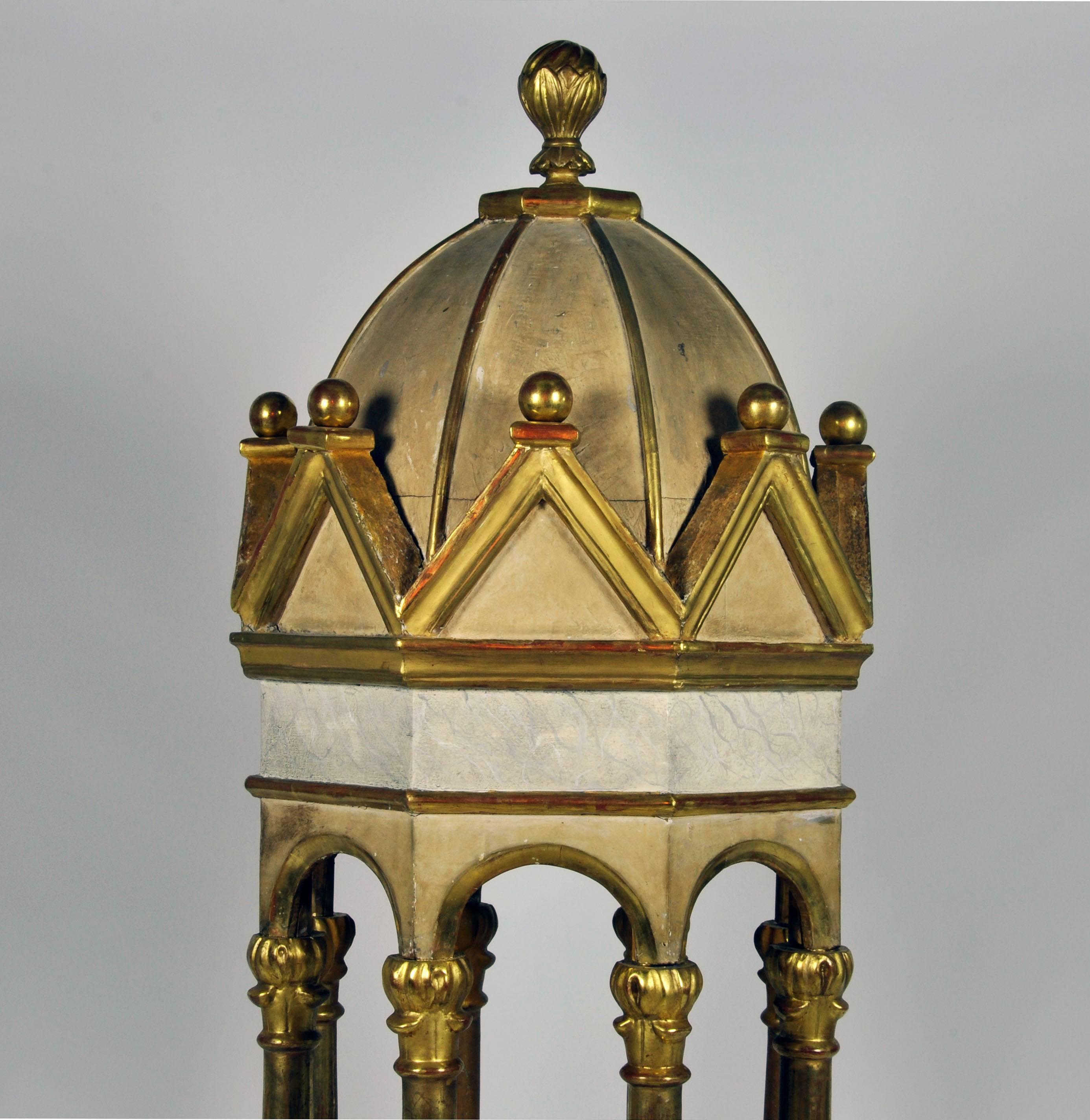 Gently restored to its former splendor this decorative paint and parcel giltwood pavilion model evokes notions of the rural churches of Northern Italy. The byzantine style gilt columns stand on a marble painted base under a likewise marble painted