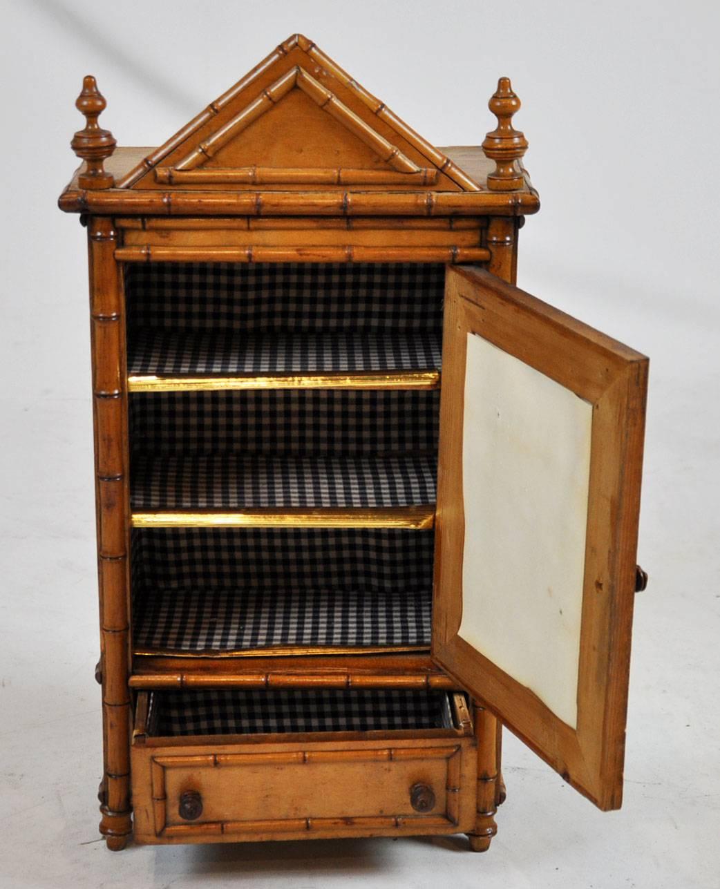 One door and one-drawer. Bird’s eye maple and bamboo, English, 19th century.