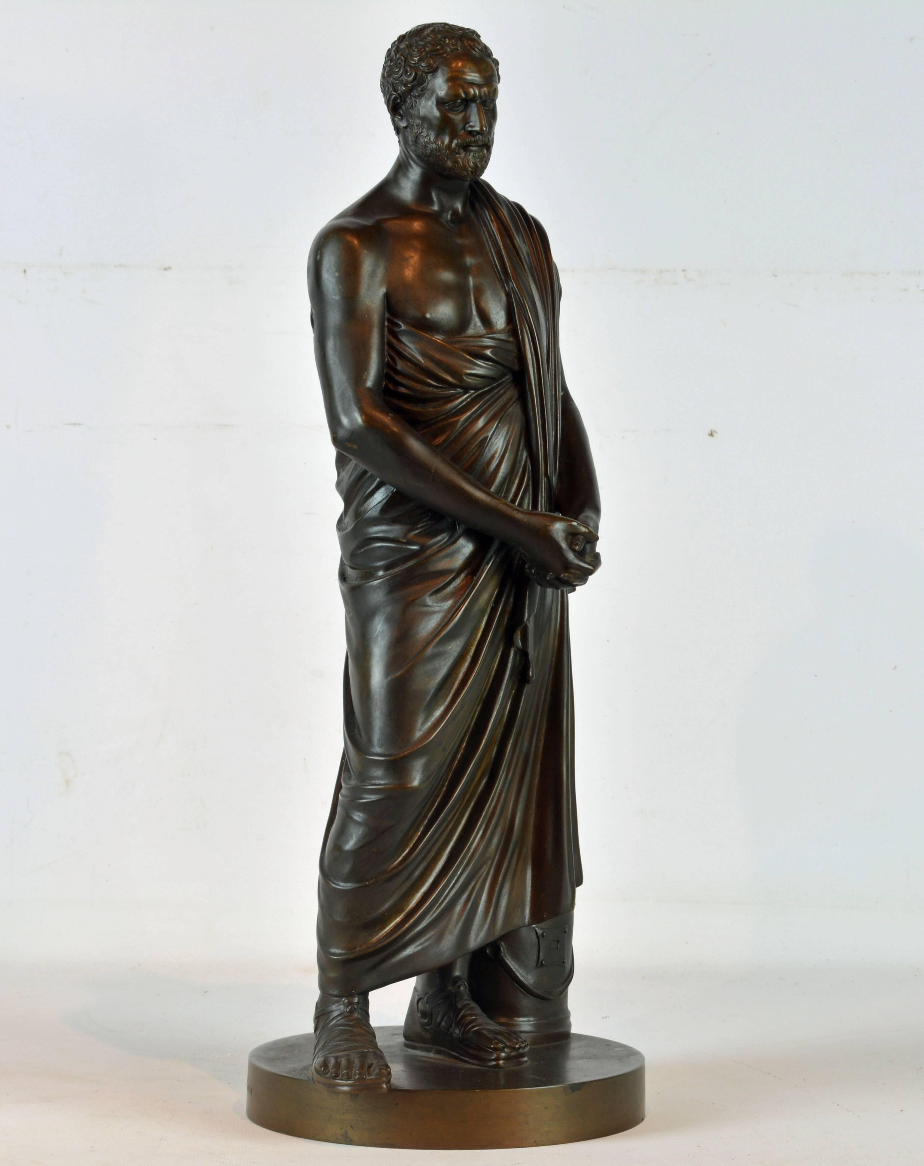 Excellently modeled and cast this classical patinated bronze sculpture of the legendary Greek statesman and orator Demosthenes (384-322 BC) stands almost 19 inches tall radiating all the intellectual virtues of the antiquity. Demosthenes lived in
