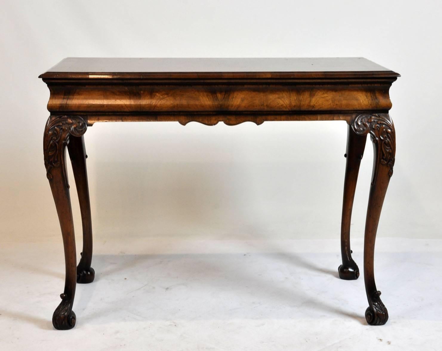 Walnut carved cabriolet leg with scrolled feet. Banding top with herring bone inlay with bookend matching veneer. It can free stand with all sides finished.