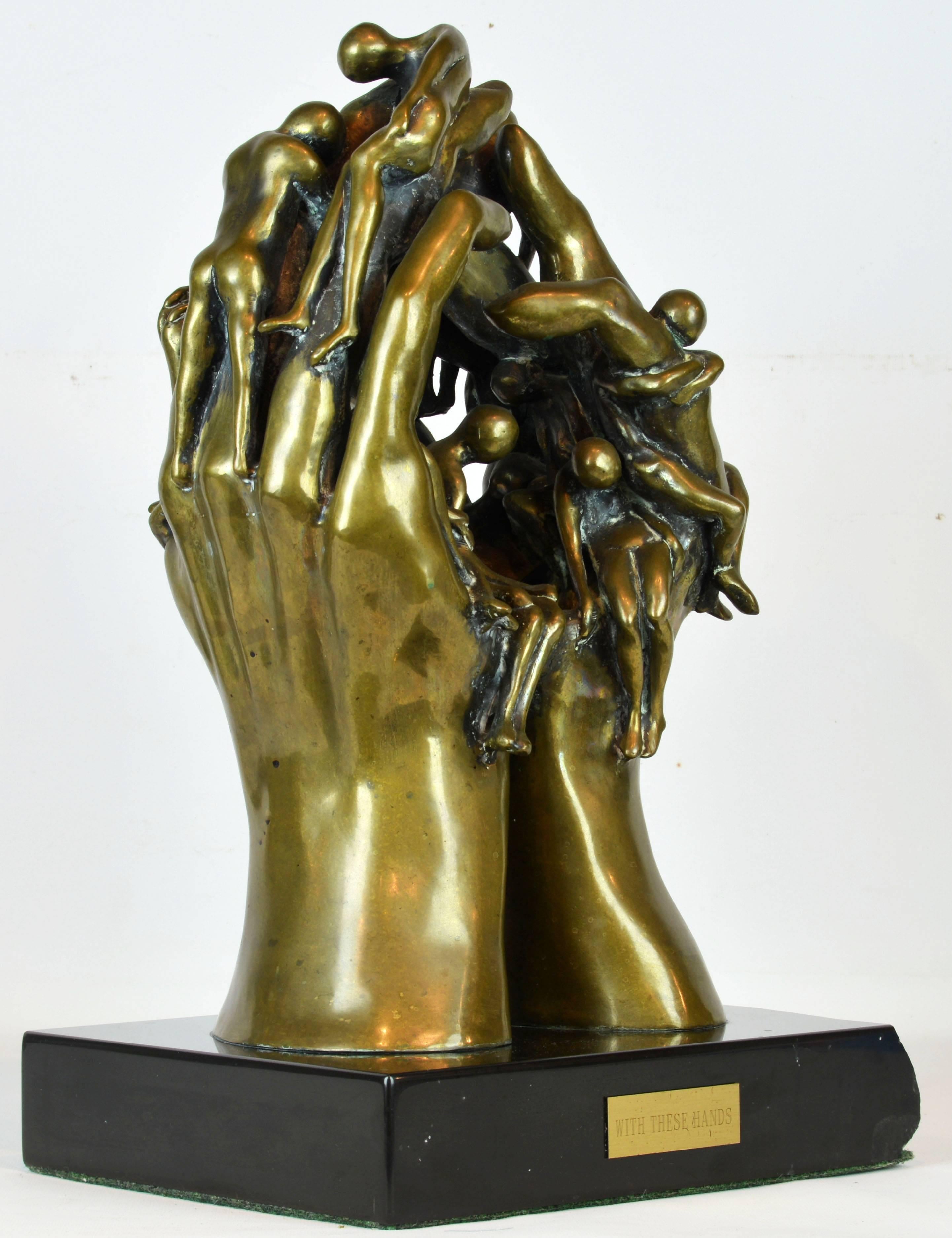 'With these hands'
A large stunning bronze sculpture group by noted American sculptor Arthur Marshak (b. 1927) representing multiple human figures and a pair of large hands set on a black marble base. The base features a brass title plaque. Signed