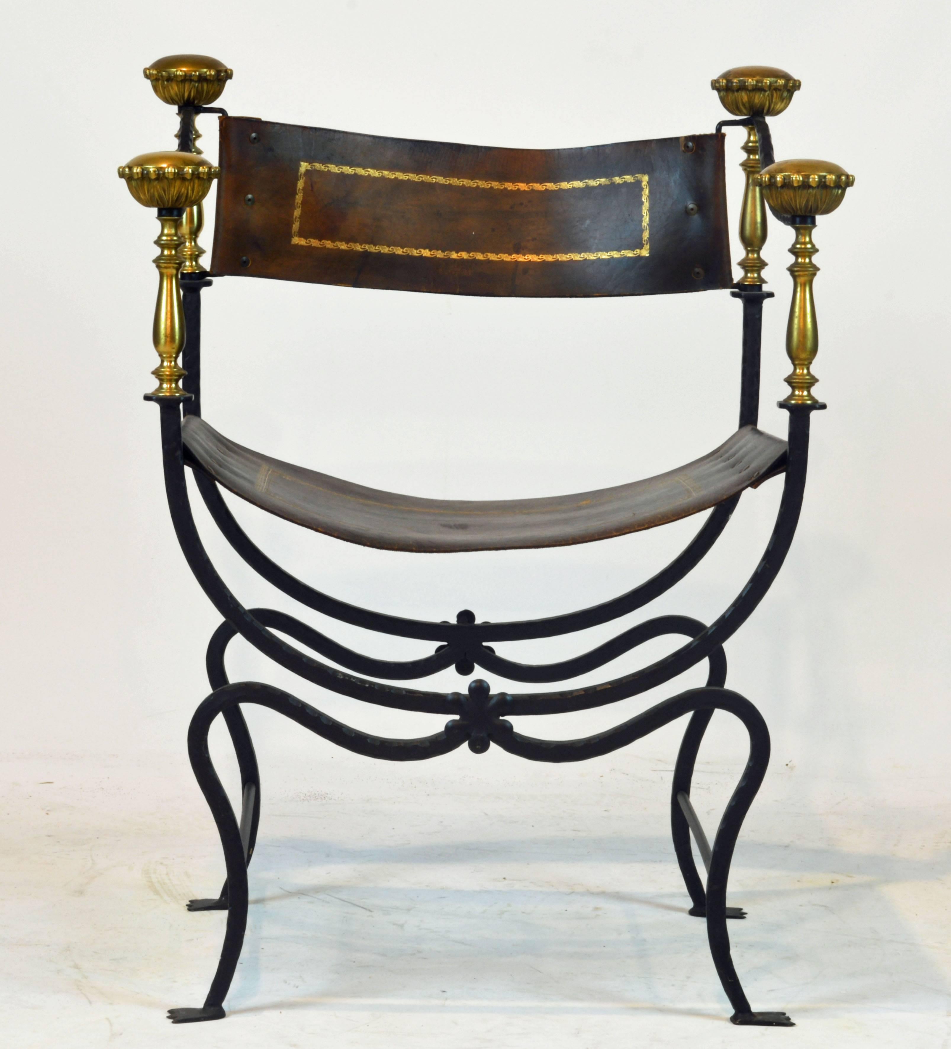 Of iconic Mediterranean design this Italian Savonarola chair features a tooled wrought frame supporting polished bronze baluster verticals surmounted by round archantus grips. The chair retains its original gilt tooled leather seat and backrest.