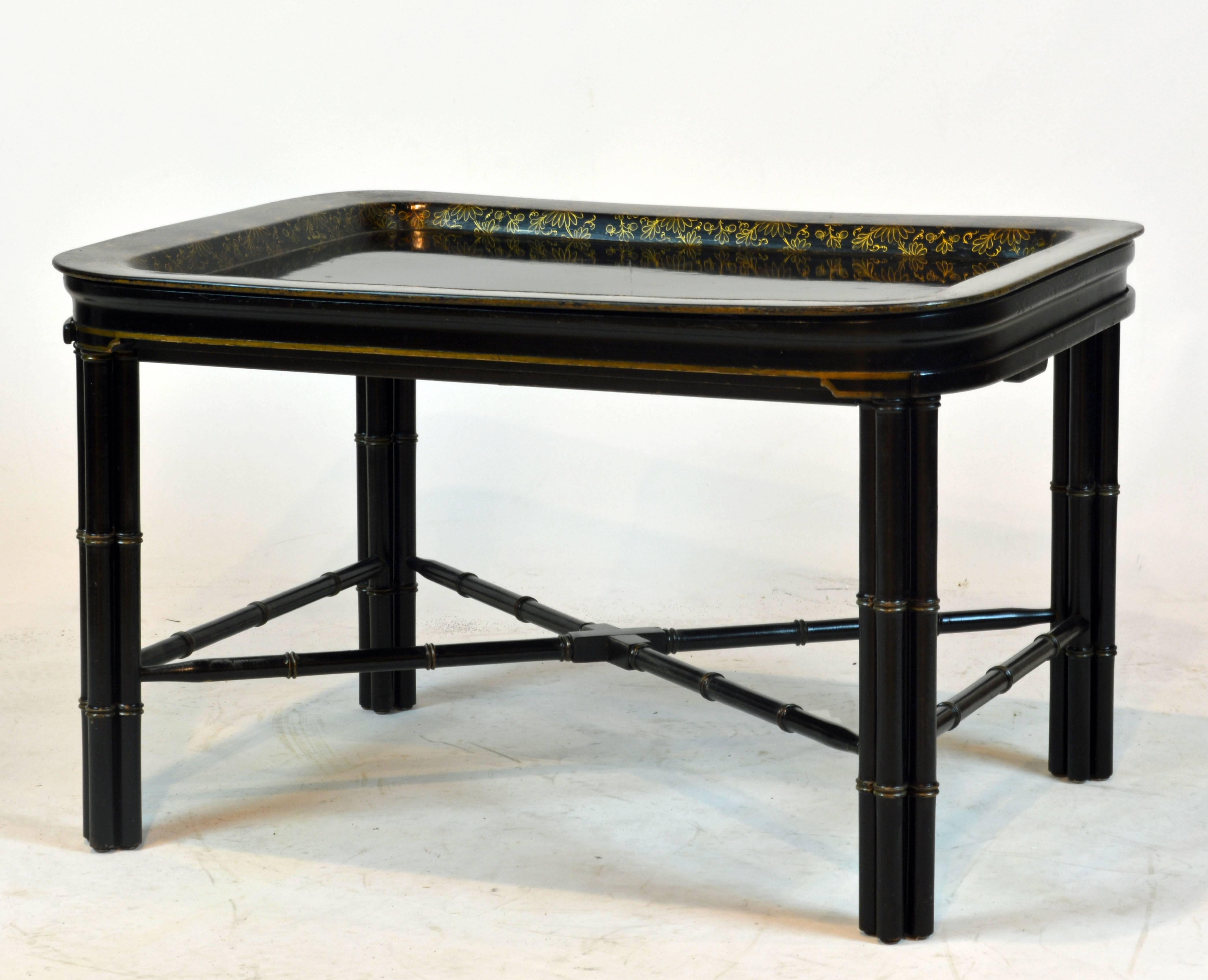 This fine and unusual table features a gilt decorated papier mâché removable tray on an elegant ebonized faux bamboo stand. If desired the table expands with pull-outs in both ends.