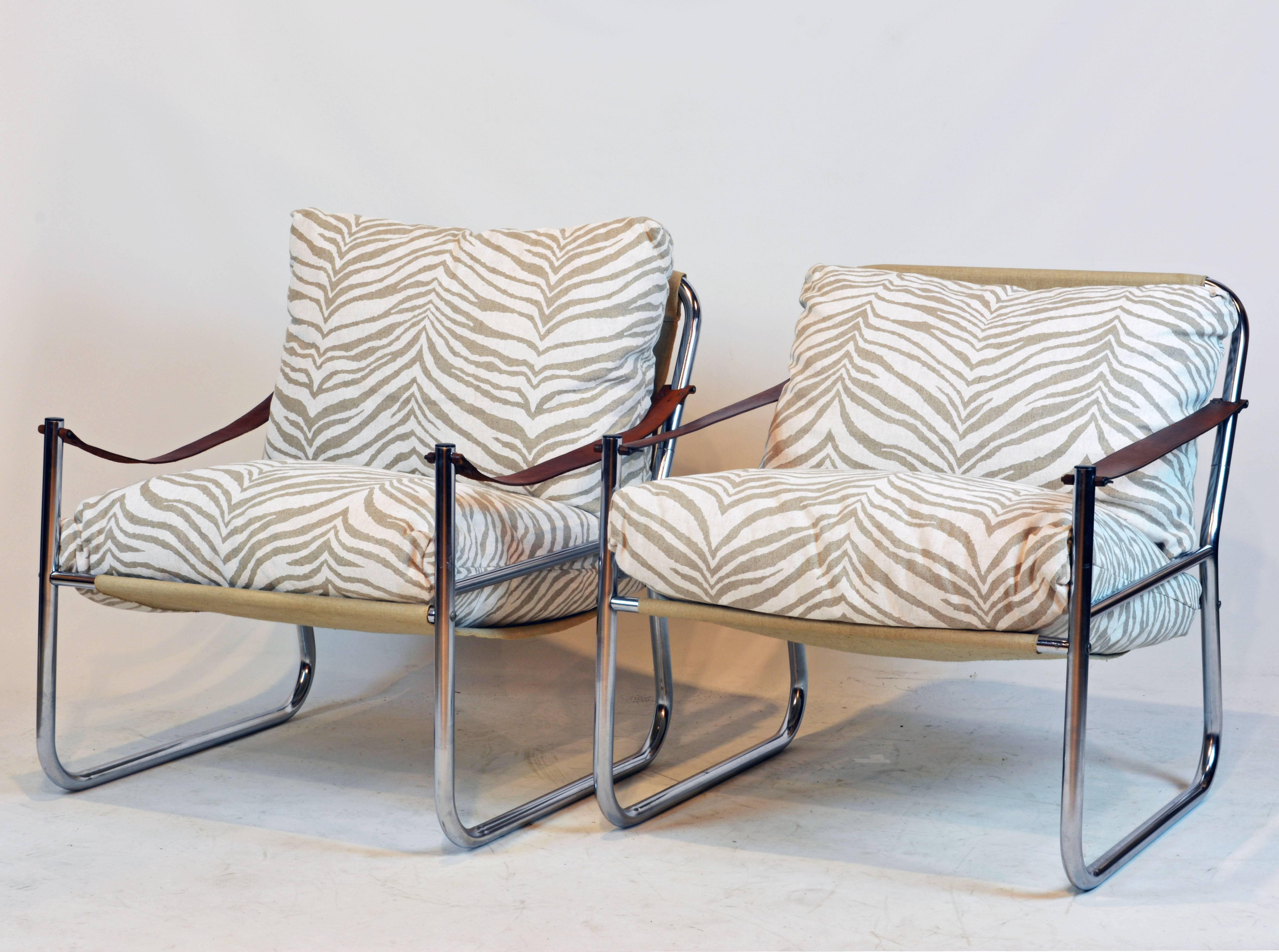 These comfortable sling style chairs feature leather strap armrests and a chrome frame supporting suspended canvas seat and back. Custom-made cushions covered with elegant gray shade zebra-pattern complete the picture.