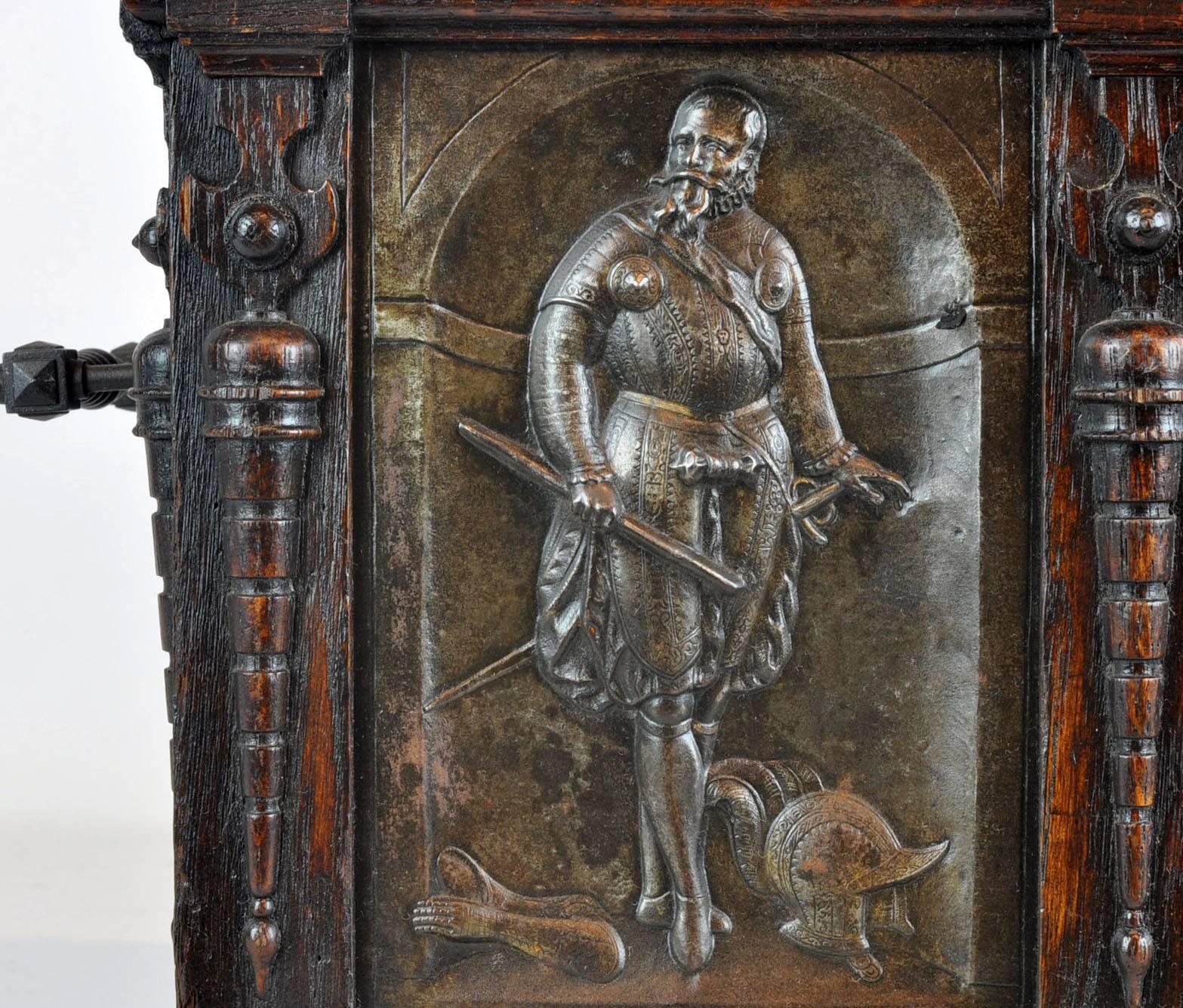 This rare box shaped like a building features inscribed bronze reliefs of the well-known original Flemish castle of Herlaar in Flanders, Belgium, flanked by full length portraits of named Renaissance noblemen in armor. The 'roof' opens to an
