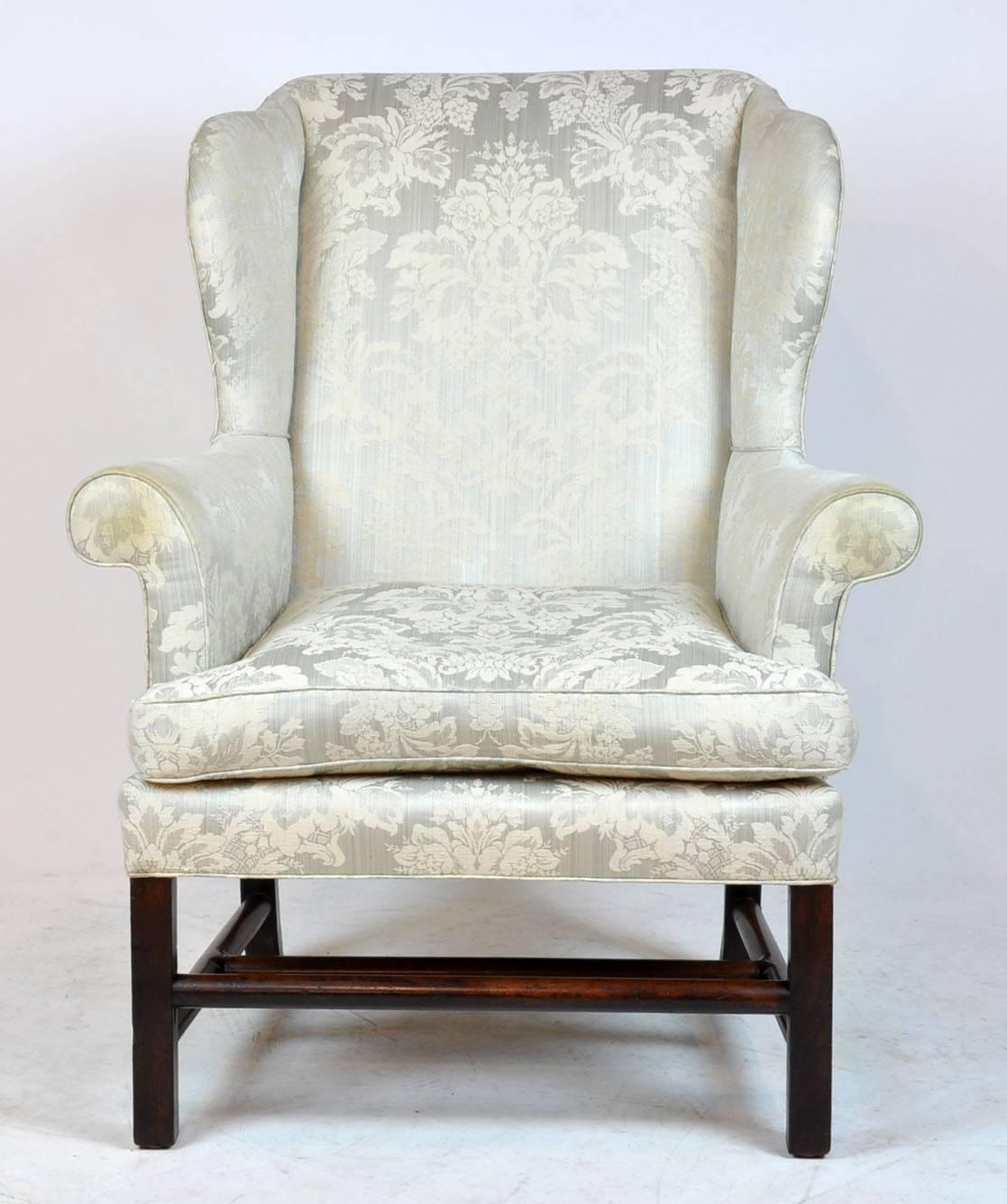 Georgian straight legged English rolled arm wing chair. Unusual turned stretcher base. Upholstery has some soiling at end of ends.