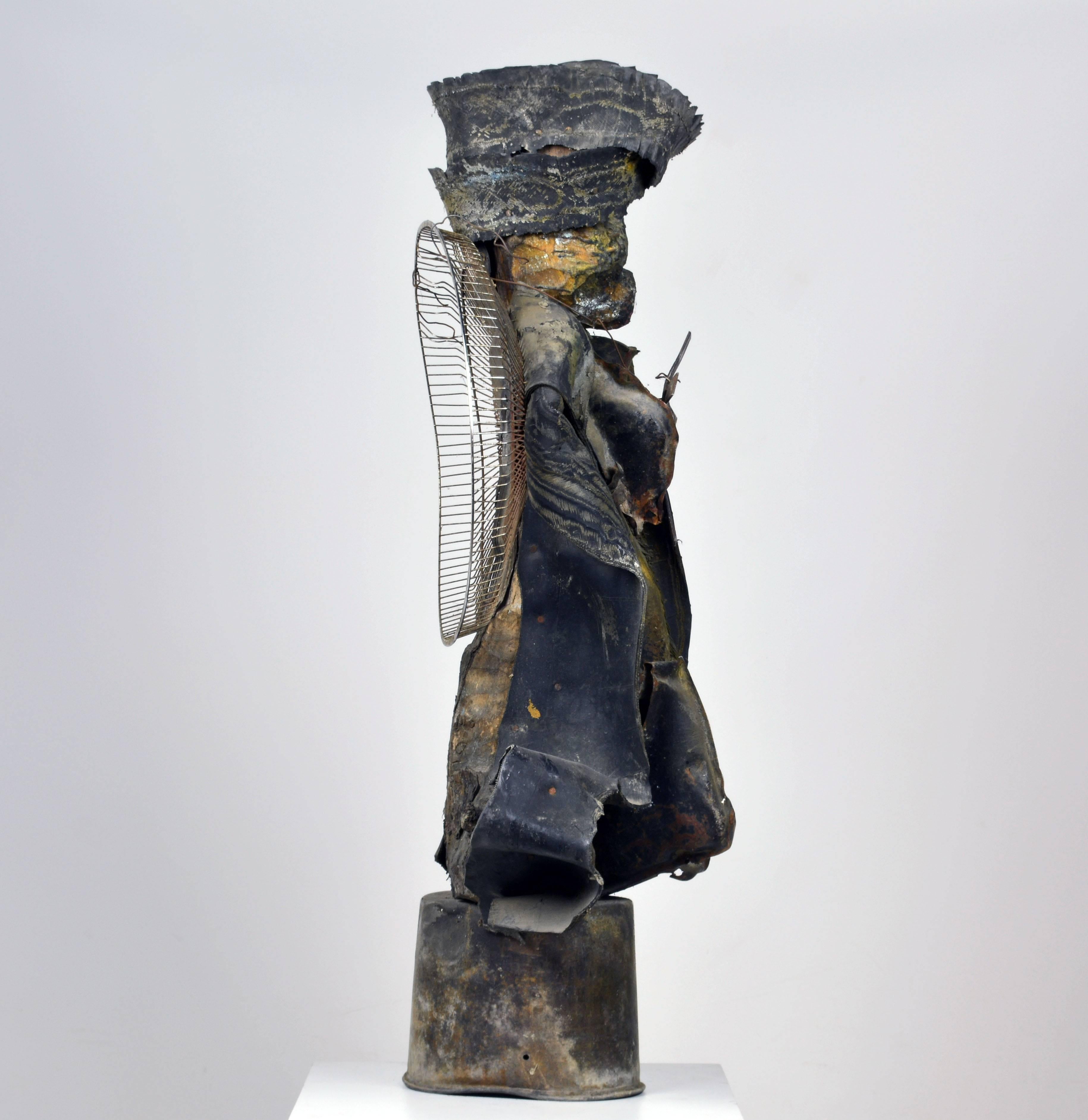 'Untitled'
by Andre Eugene, Haiti b. 1959.
Metal, wood and rubber. signed, H 43 inches.
Provenance: The Jorgen Leth Collection of Haitian Art.

Andre Eugene:
Euge`ne started out as a house builder, but influenced by the creative energy of his