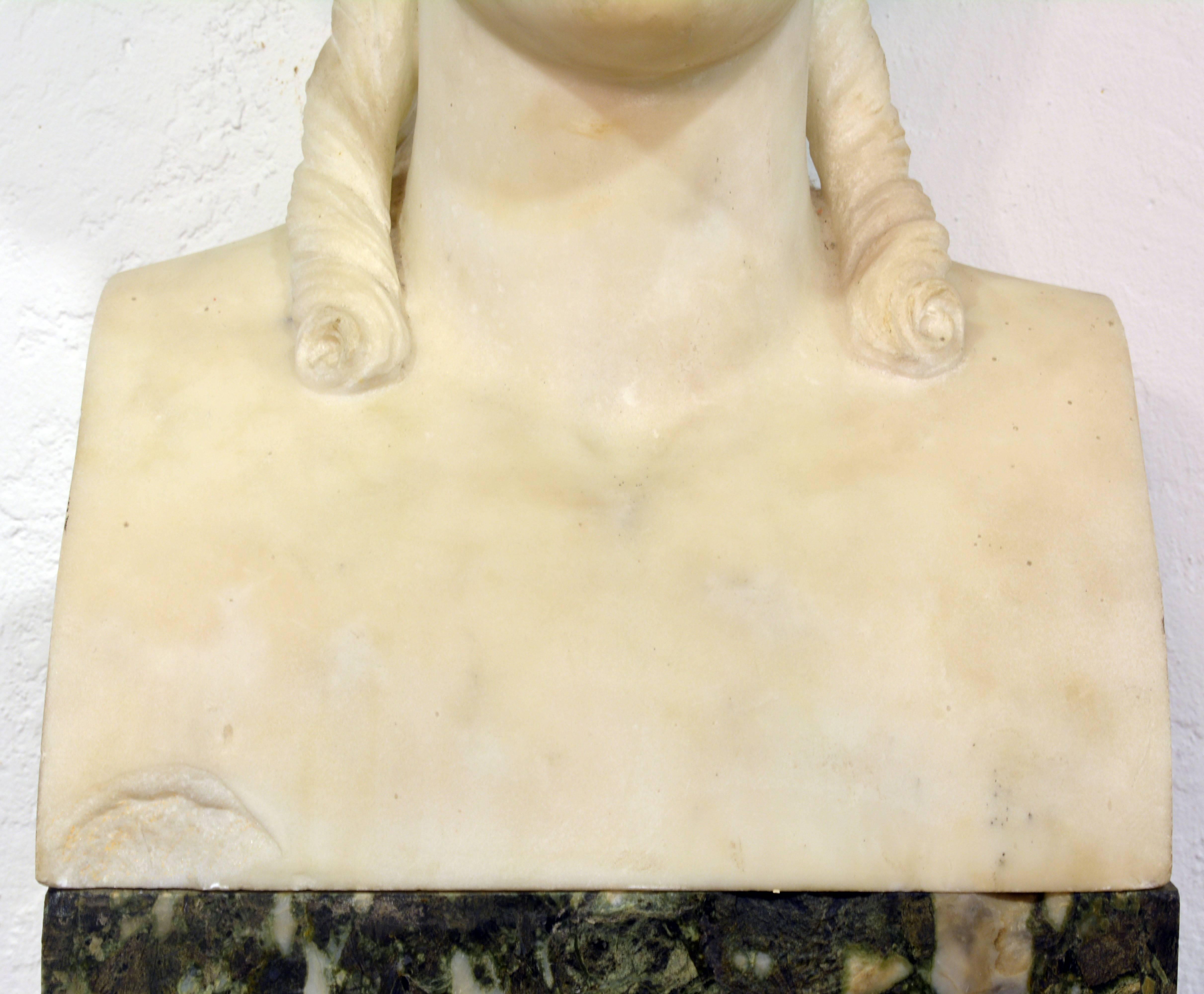 Standing 84 inches tall the marble bust of the Greek goddess Nike (Roman: Victoria), goddess of victory, is placed upon a tall square column of Italian back and white marble terminating in a carrara marble molded base.