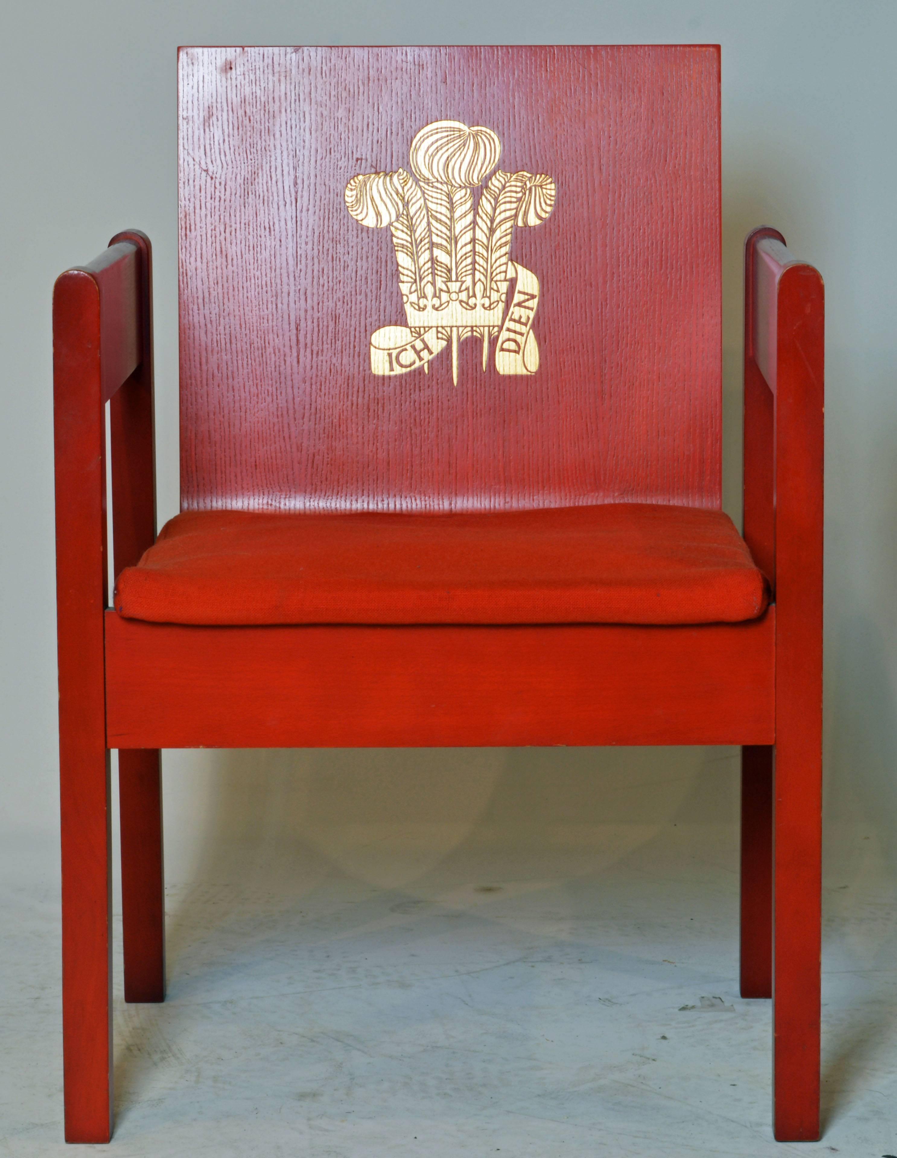 A Prince Charles investiture chair designed 1969 by Lord Snowdon (Anthony Armstrong Jones) of laminated ash painted red with slightly indented gilt Prince of Wales feathers and his motto ICH DIEN (I serve). Seat upholstered in red Welsh tweed. W