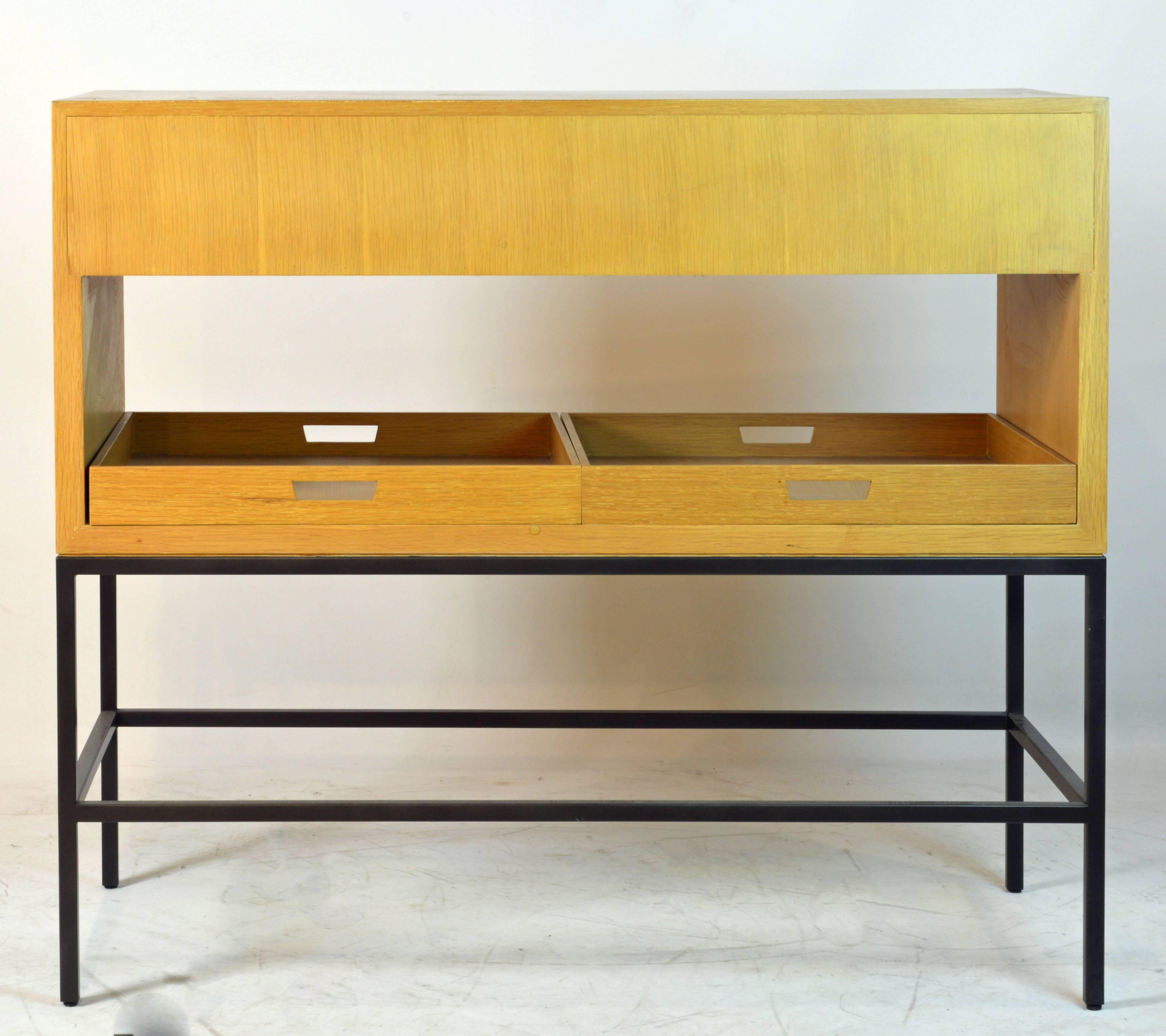 Great Minimalist design by Vanderbyl, one of the leading designers of today. The piece features two drawers, pull outs in both ends and two removable trays all resting on a lacquered four leg steel frame. The quality of the malerials and