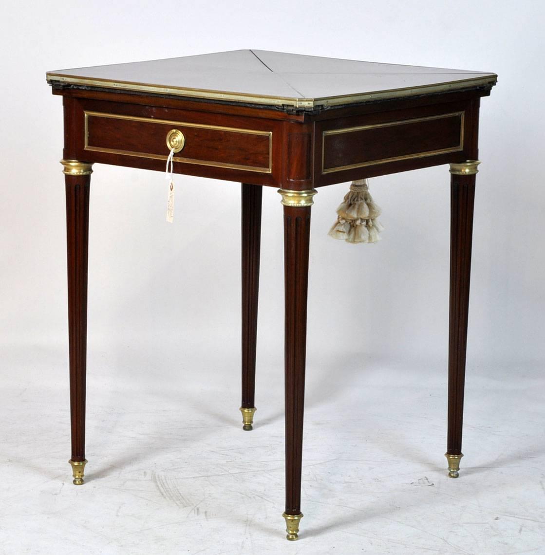 Late 19th century French handkerchief game table. Bronze mounts with spindle legs. Two drawers and fold out top to felt interior. Mahogany wood. Great condition.