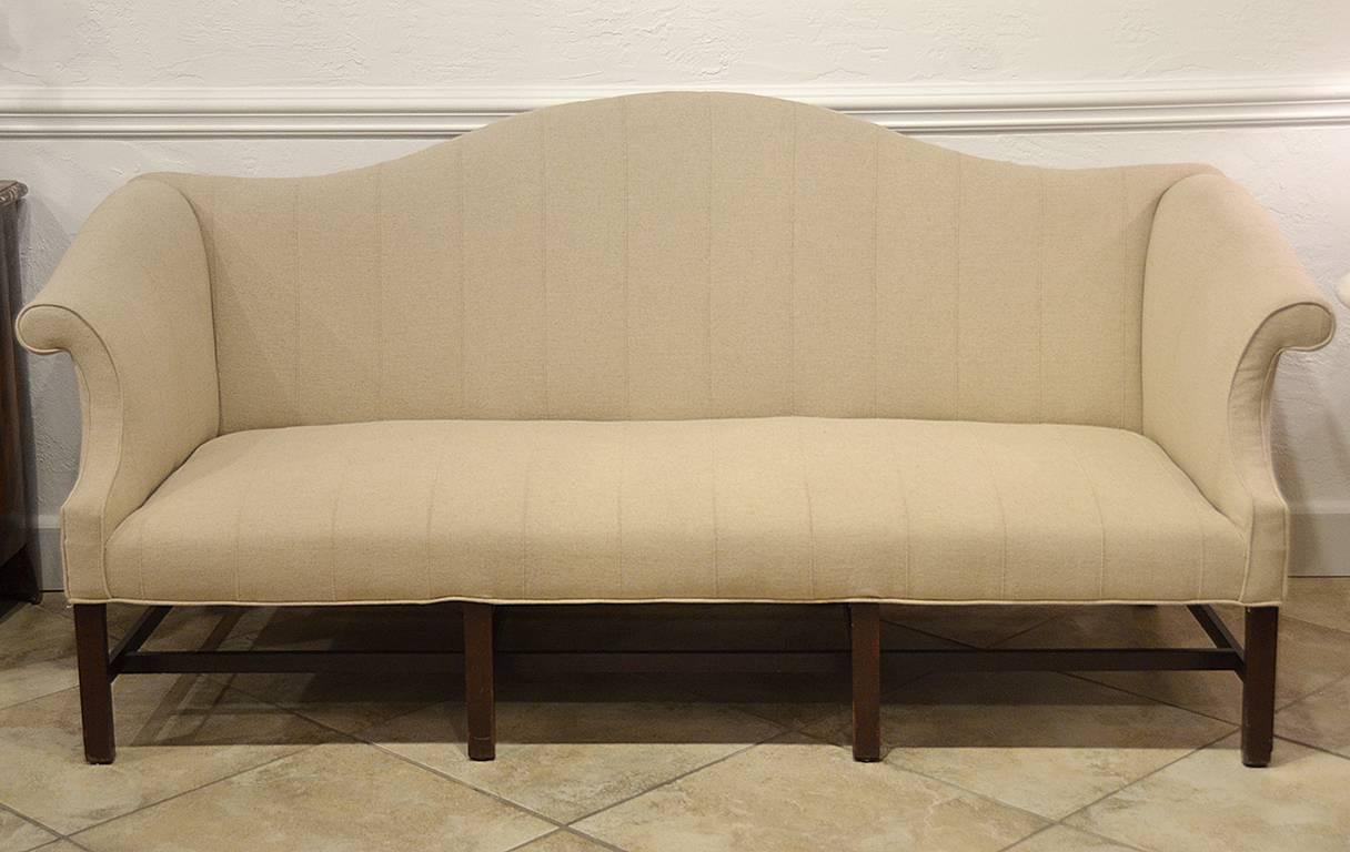 English mahogany camel back sofa. Chippendale rolled arm. Late 18th century. Newly upholstered. Very good condition.