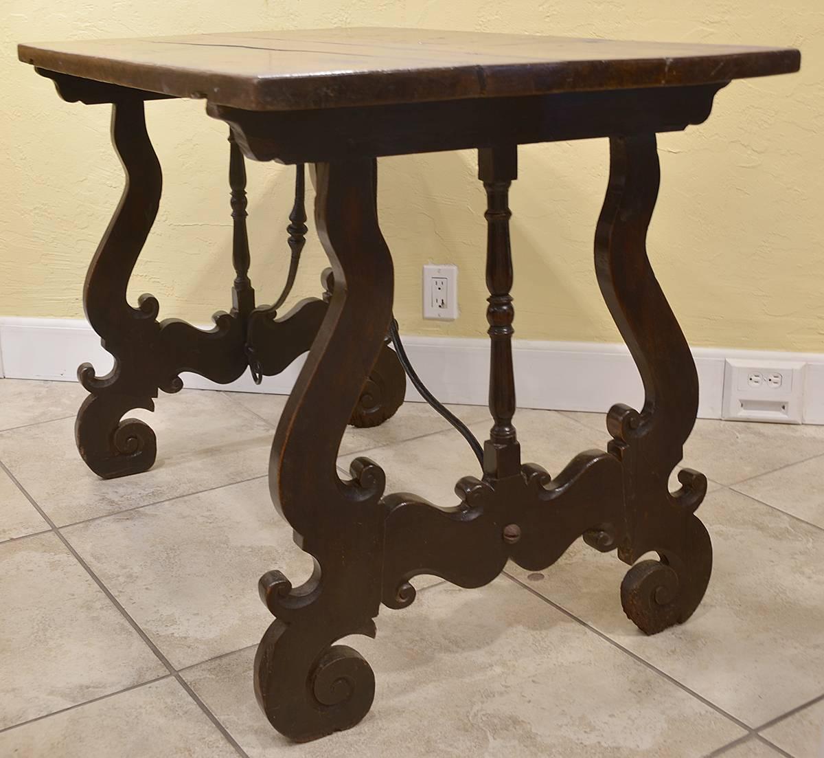 18th century Spanish walnut table with scrolled iron supports. Good condition based on age.