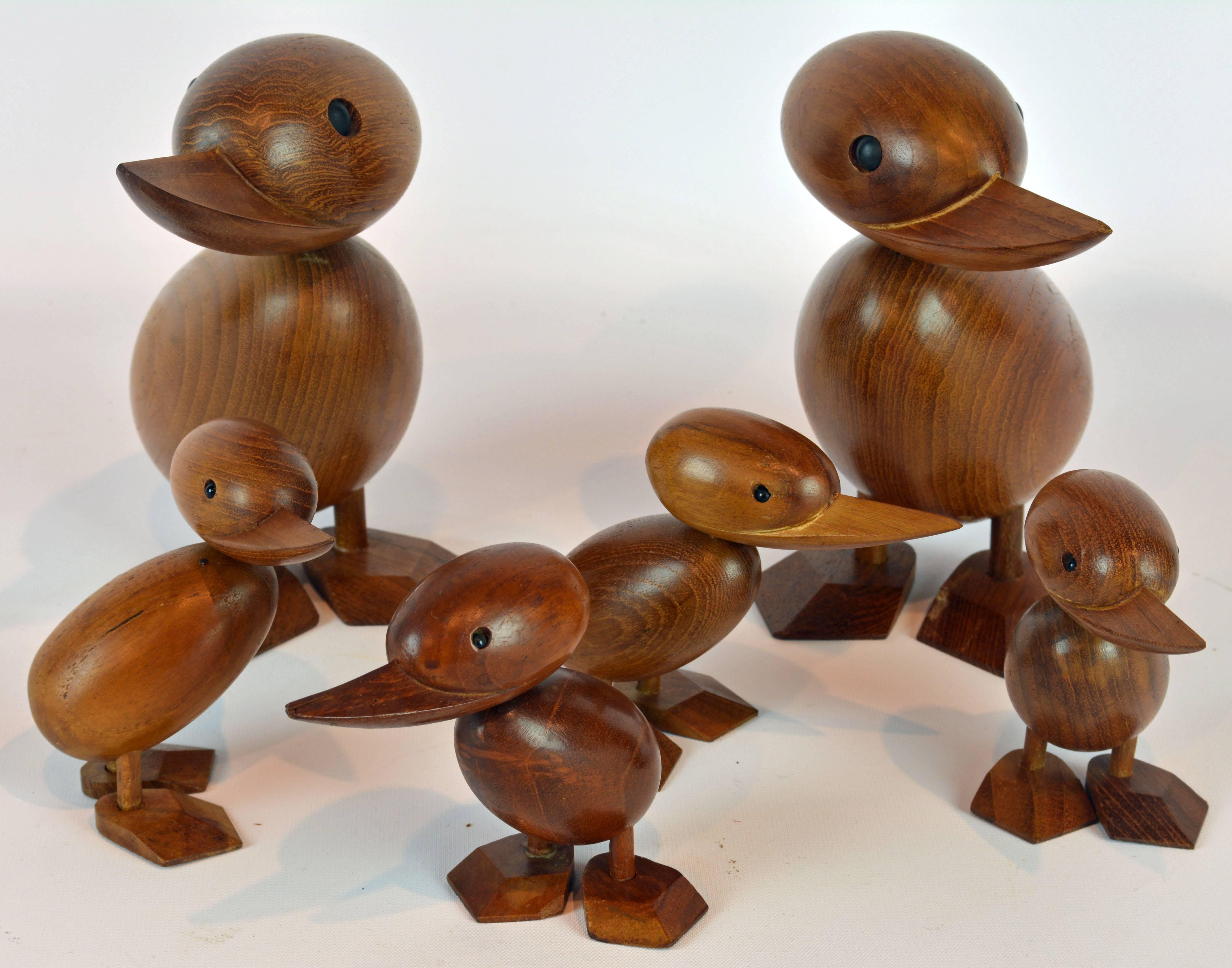 Designed by Hans Bolling, Denmark, these iconic ducks likely from the 1960s are handmade of teak wood with beautiful grain and have black shiny eyes. The larger ducks Stand 7.25 inches tall and the smaller 4.25 inches.