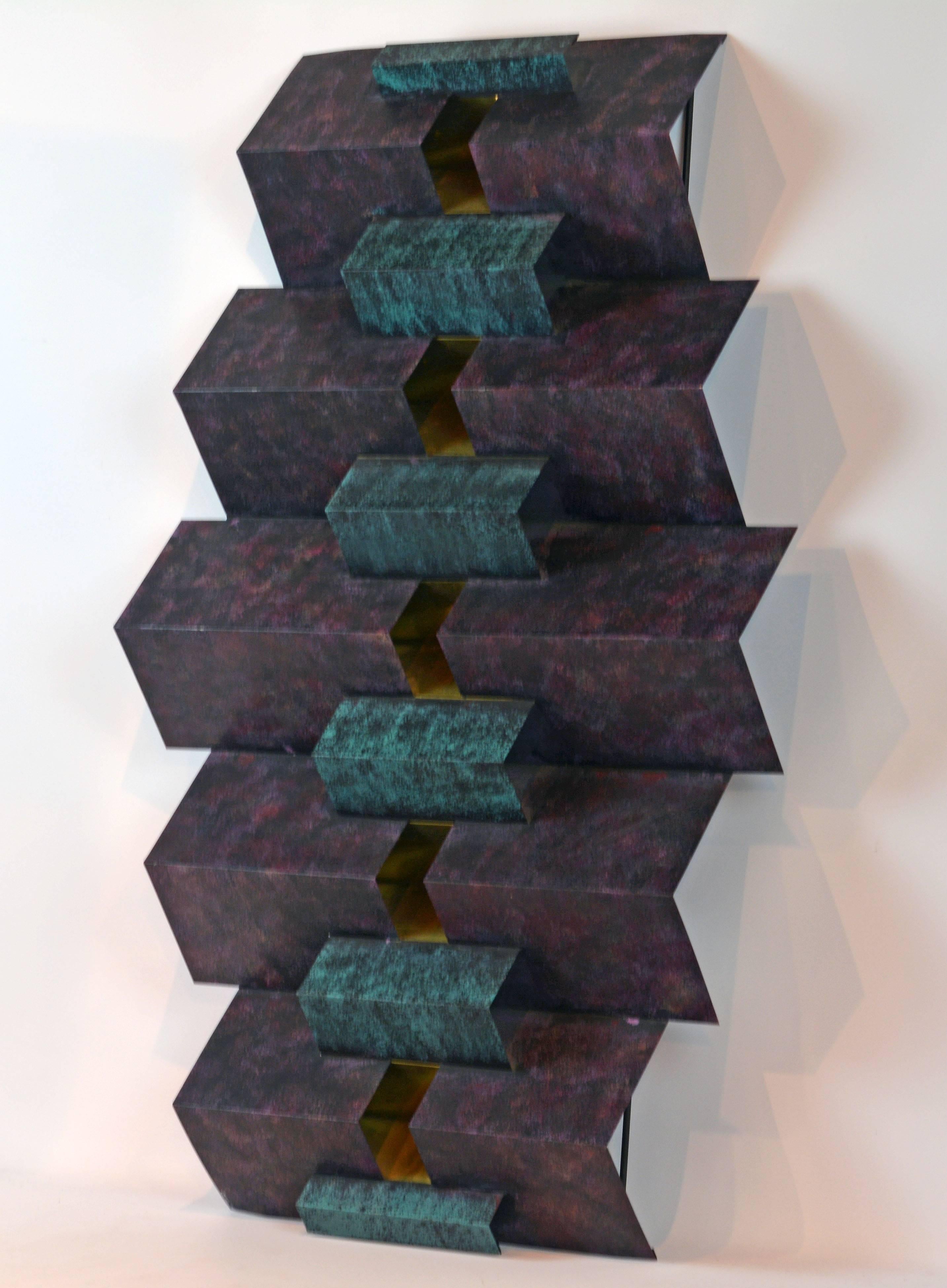 43 inches tall this sculpture intricately combines angled painted elements with an centre core of polished brass angles. In the light it takes on its own life of color of form in ever changing views. It is signed and dated on the lower left