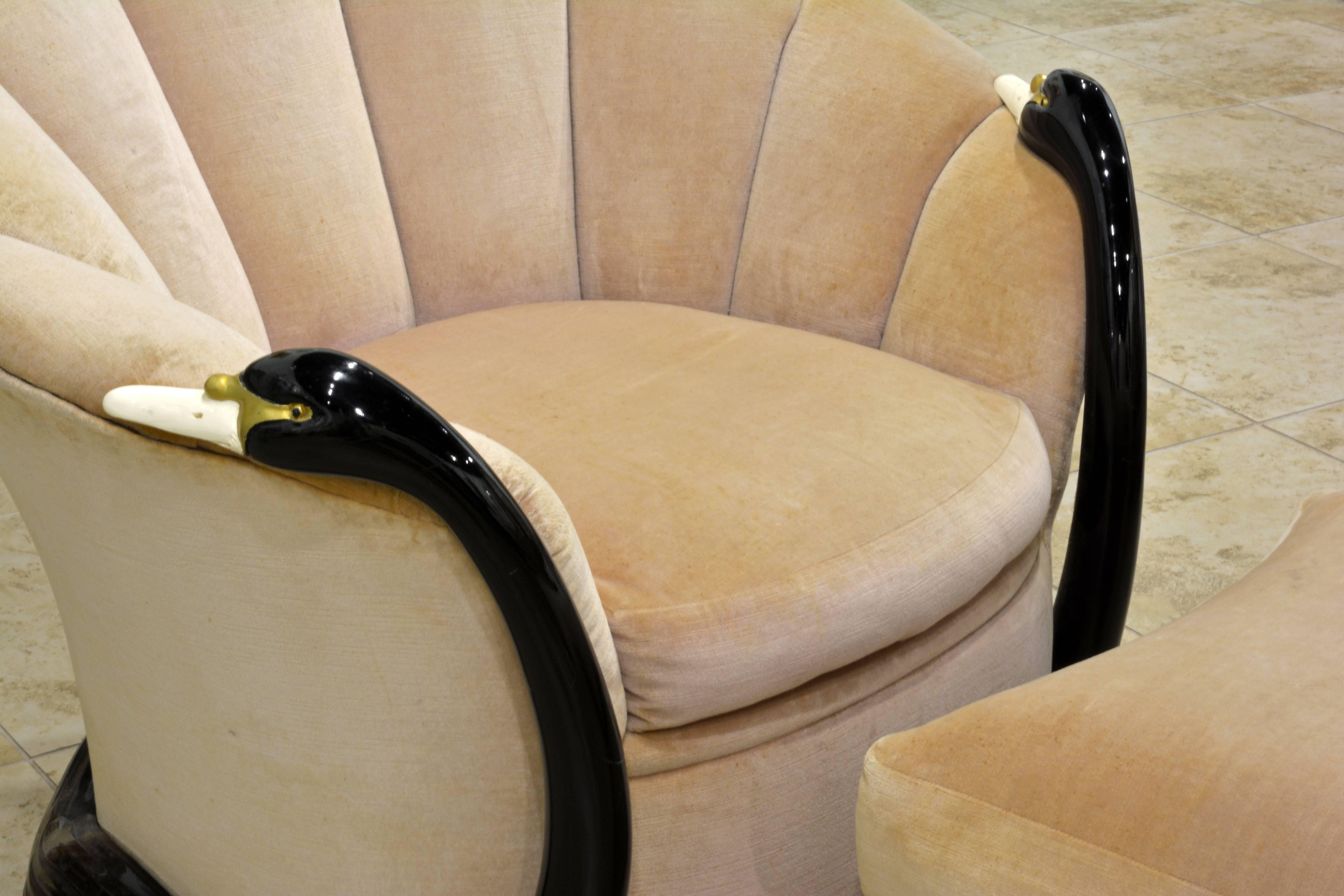 This chair features a chic fan shaped channel back design, with carved and lacquered swan sculptures that wrap around the back and up the sides to form the armrests, a truly unique and unusual Hollywood Regency design by the legendary Vermillion of