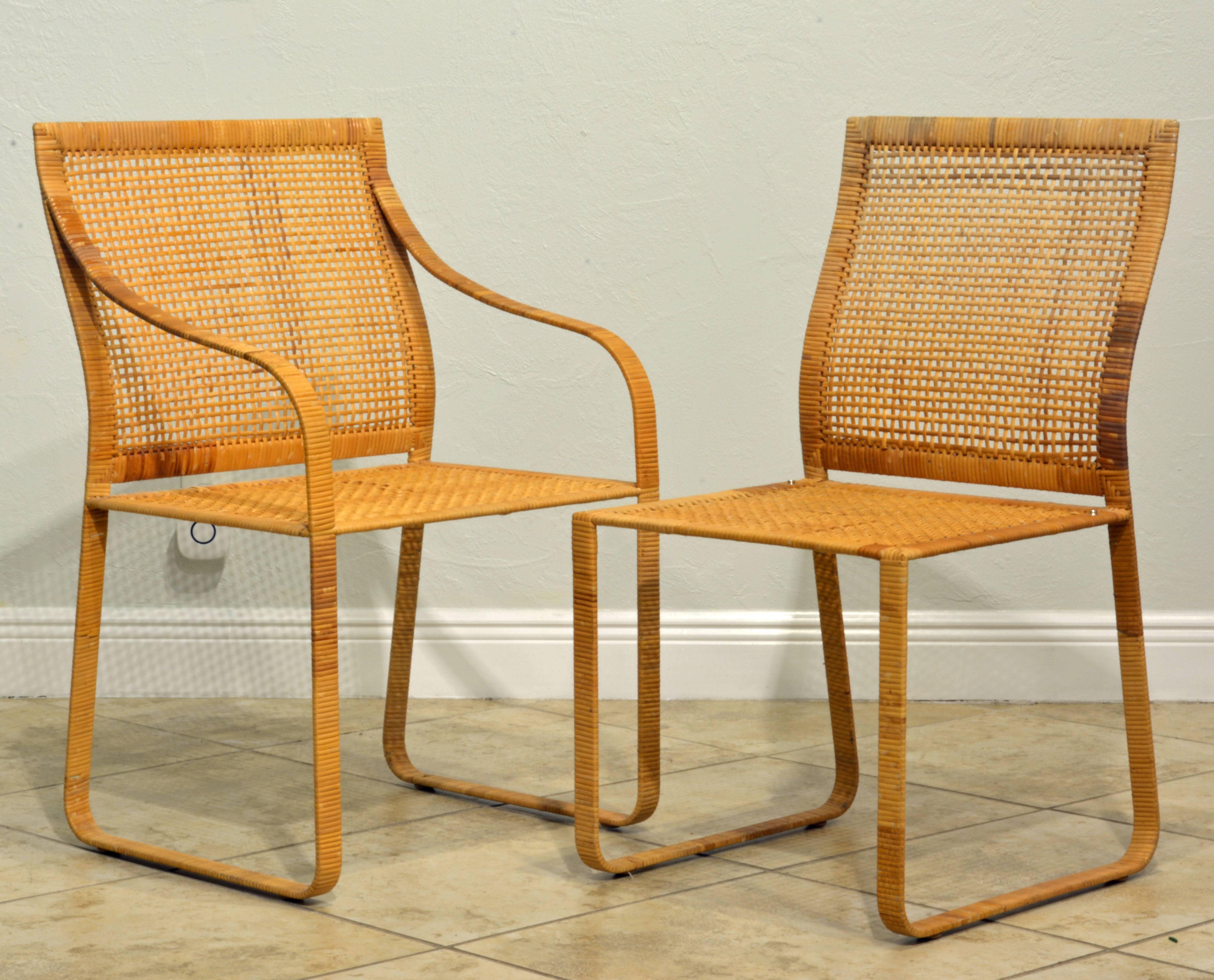 A set of six Harvey Probber dining chairs. Two-arm chairs and four side chairs. Woven rattan over steel frames. Overall great condition. Seats and backs with no breaks. A few loose woven ends on arms or legs. Not marked. Very heavy and sturdy. Comes