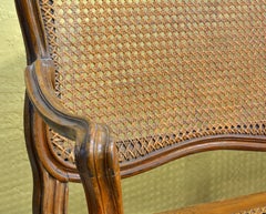 Late 18th Century Provincial Louis XV Style Carved and Caned Walnut Settee