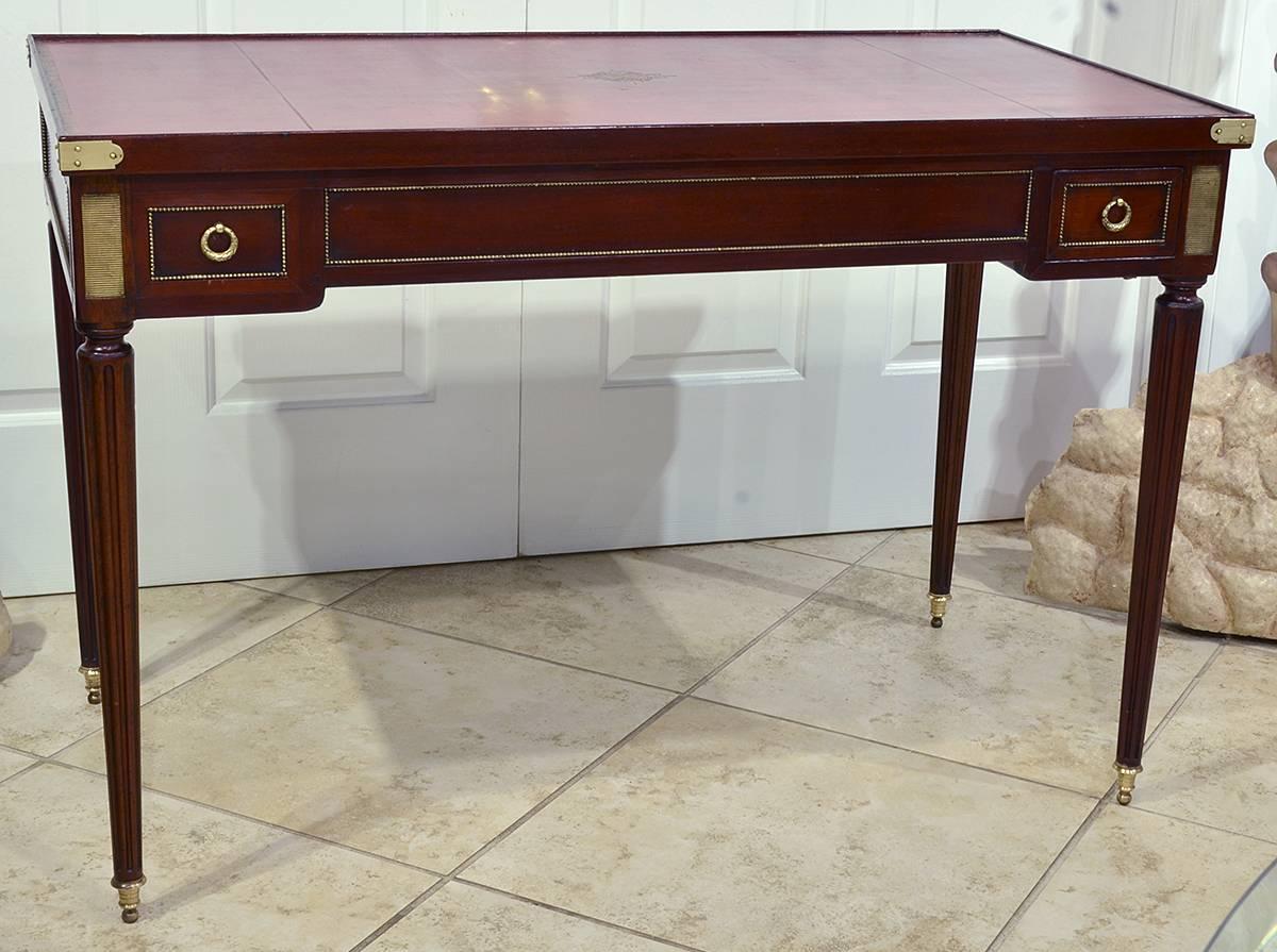 Louis XVI style Tric Trac table. Beautiful red leather tooled top. Ebony and bone gable table on other side. Fluted legs, late 19th century. With the top off, a backgammon board is exposed. Two drawer.