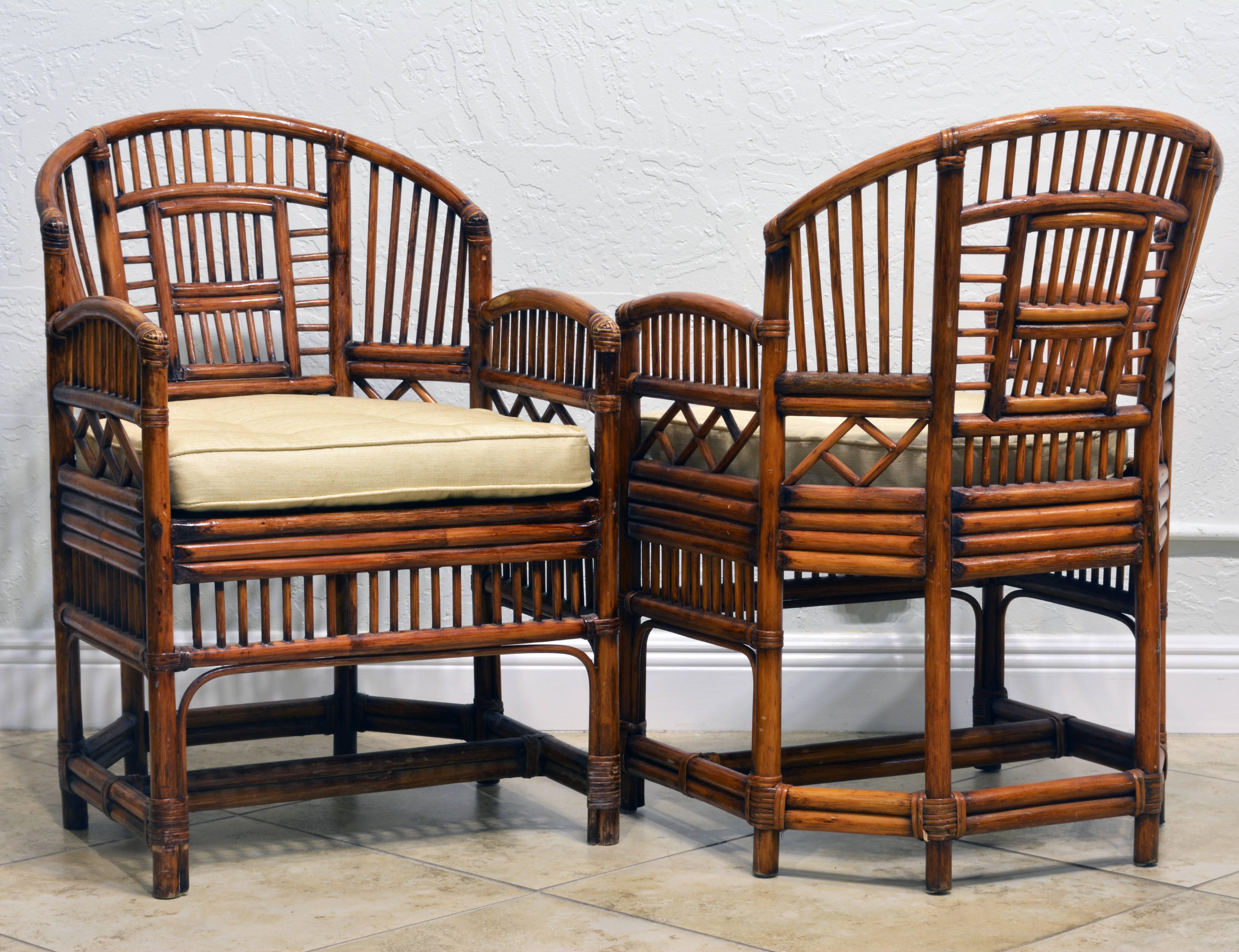 Rising on six legs these intricately crafted iconic chairs with cane seats feature bamboo frames and Chinese themed bamboo open work inspired by Chippendale design. The chairs come with new off-white silk cushions in pristine condition.