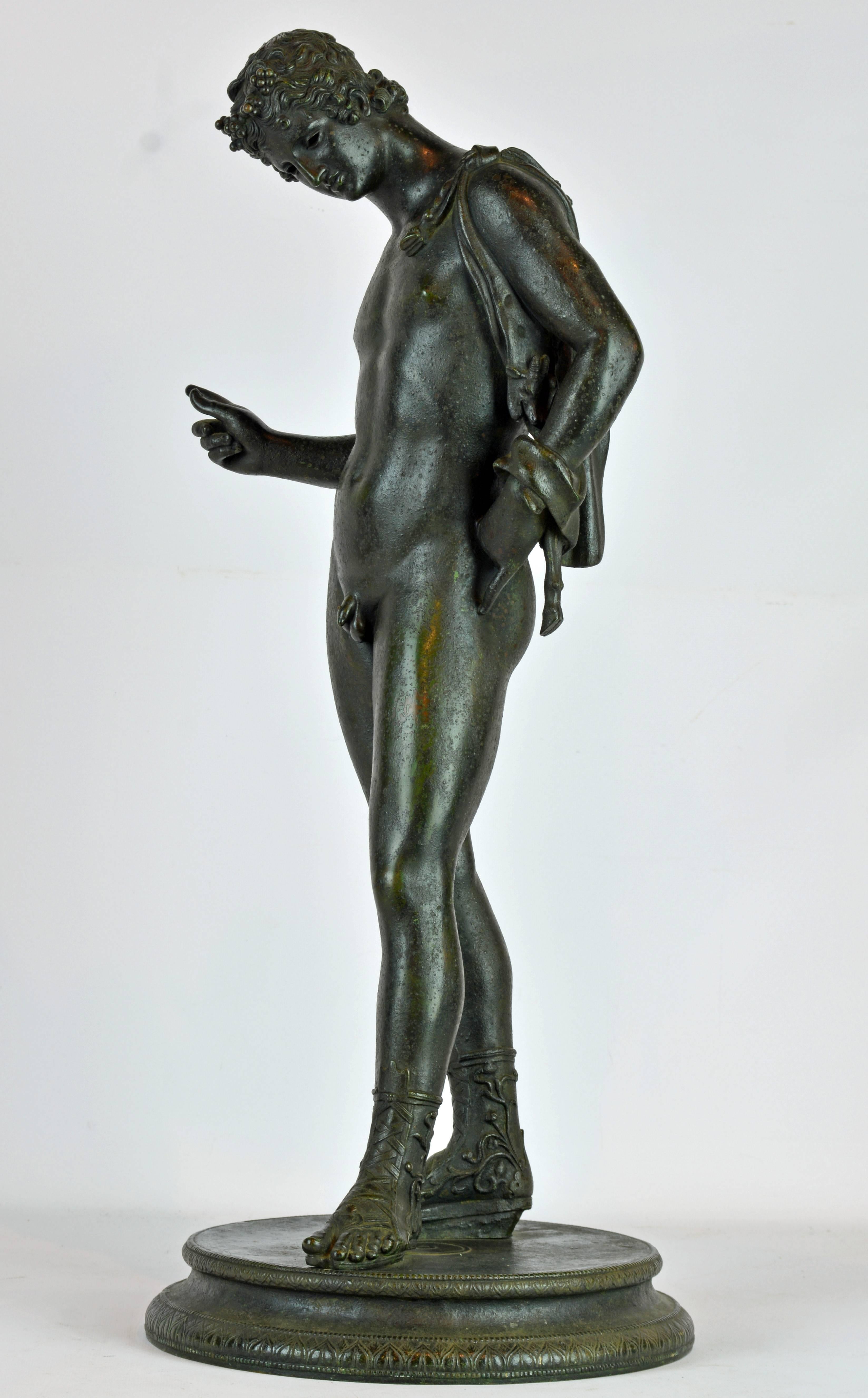 Standing 24 inches tall this statue depicts Antinous who was a close friend or lover og emperor Hadrian. After his untimely death Hadrian deified him. Standing in the nude on a circular base he is wearing a goatskin water container over his left