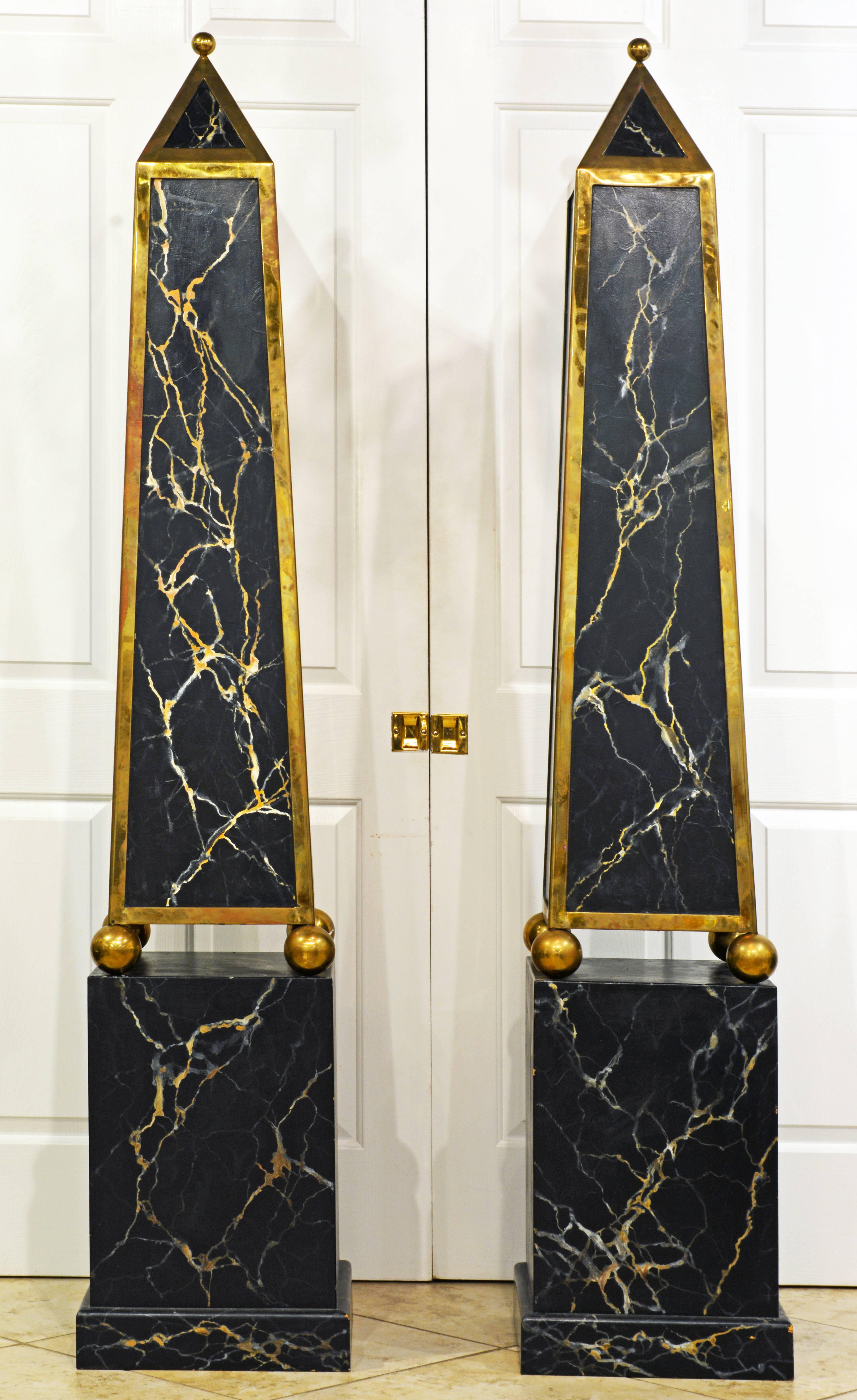Standing an impressive 81 inches tall these magnificent obelisk models feature upper solid brass mounted and marble painted sections surmounted by finials and resting on solid brass spheres on square likewise marble painted bases. Each obelisks has