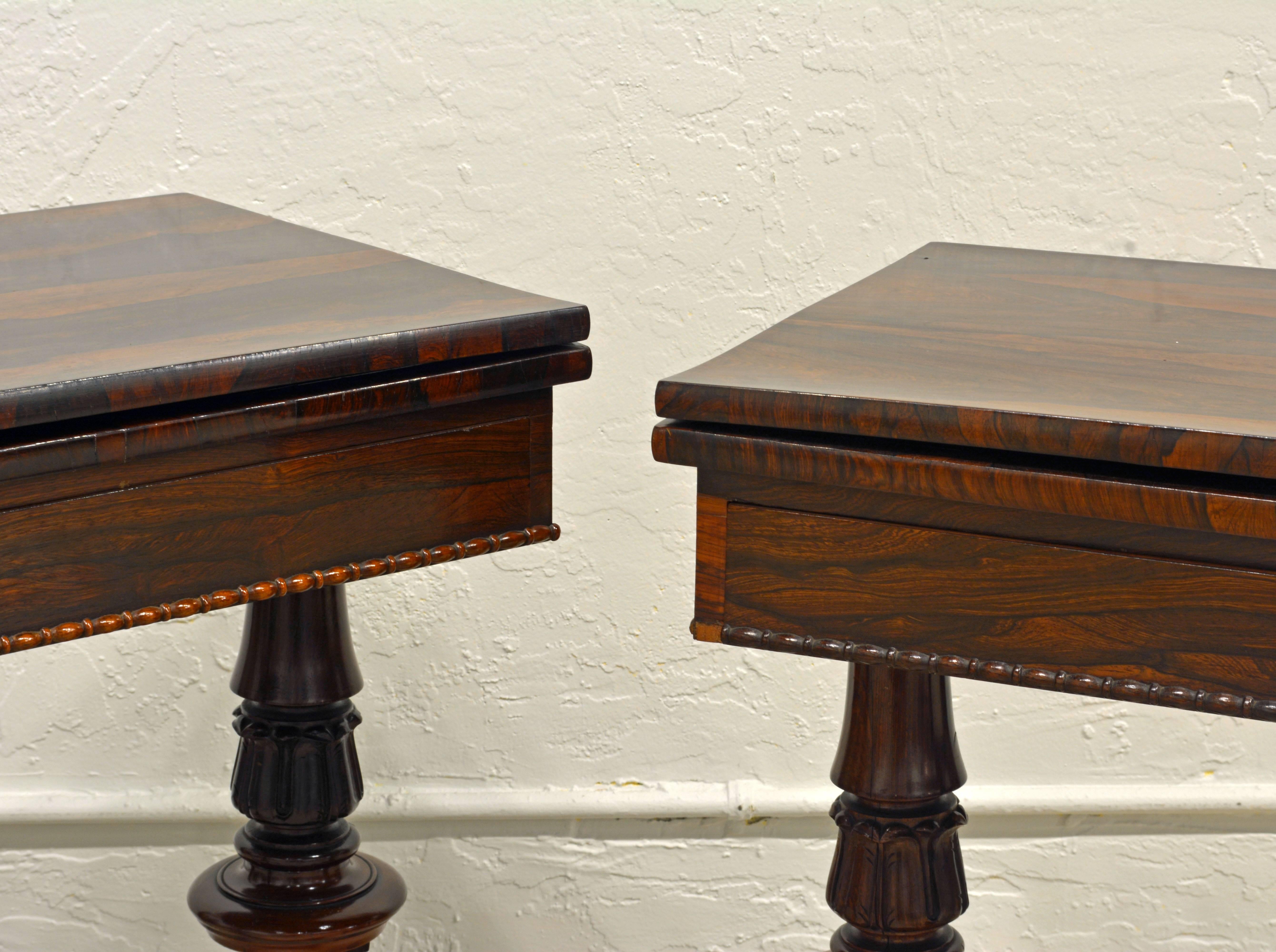 These tables of warm and glowing rosewood open up to full size for game purposes but are equally beautiful in their folded console style position. They are supported by richly carved and turned twin pedestals united by low turned stretchers and