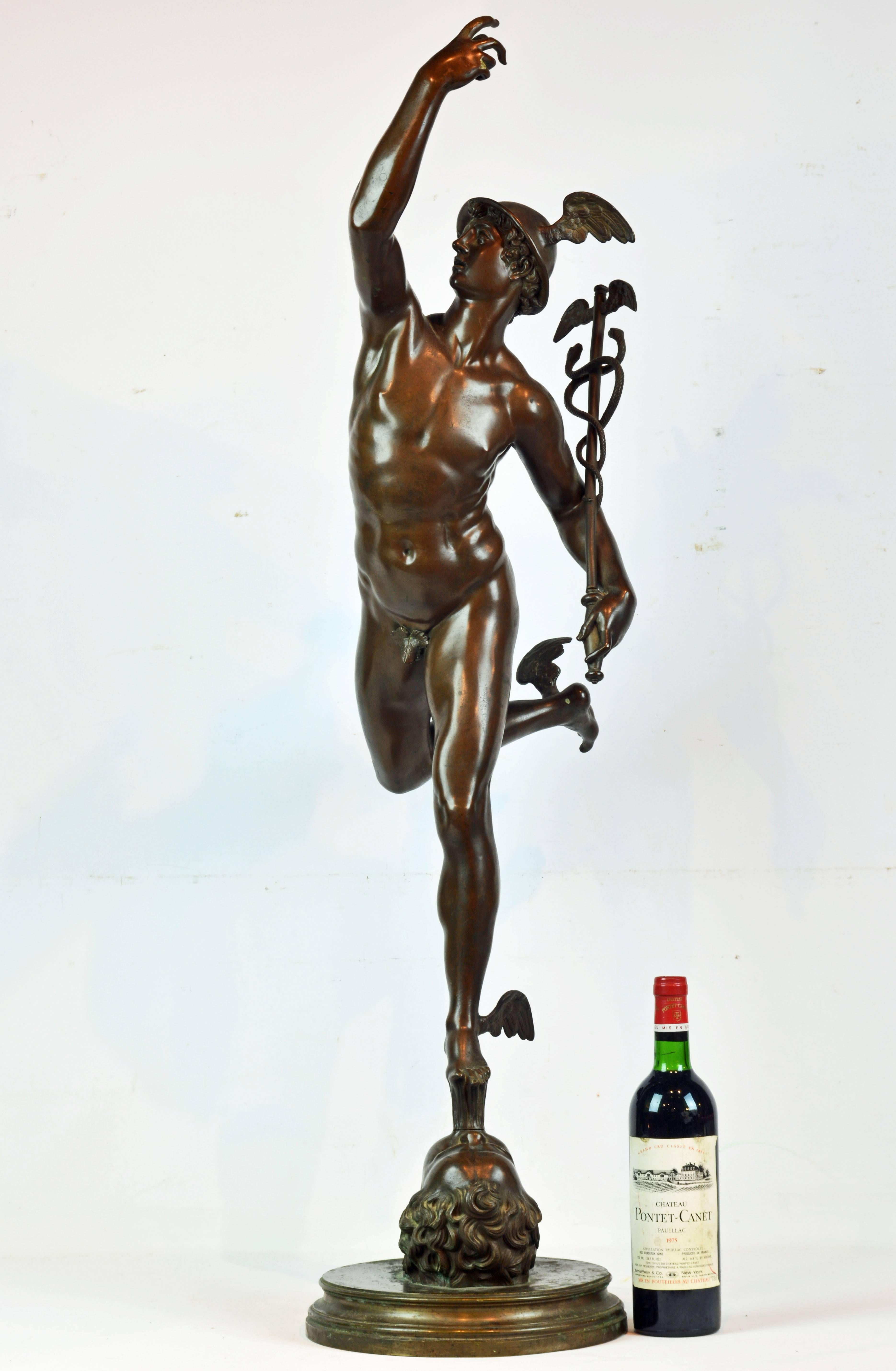 Standing almost 44 inches tall and raised on a circular molded base Mercury (or Greek: Hermes) stands balancing on an allegory of the North Wind in a powerful pose holding the 'caduceus' in his left hand. The statue is modeled after the original by