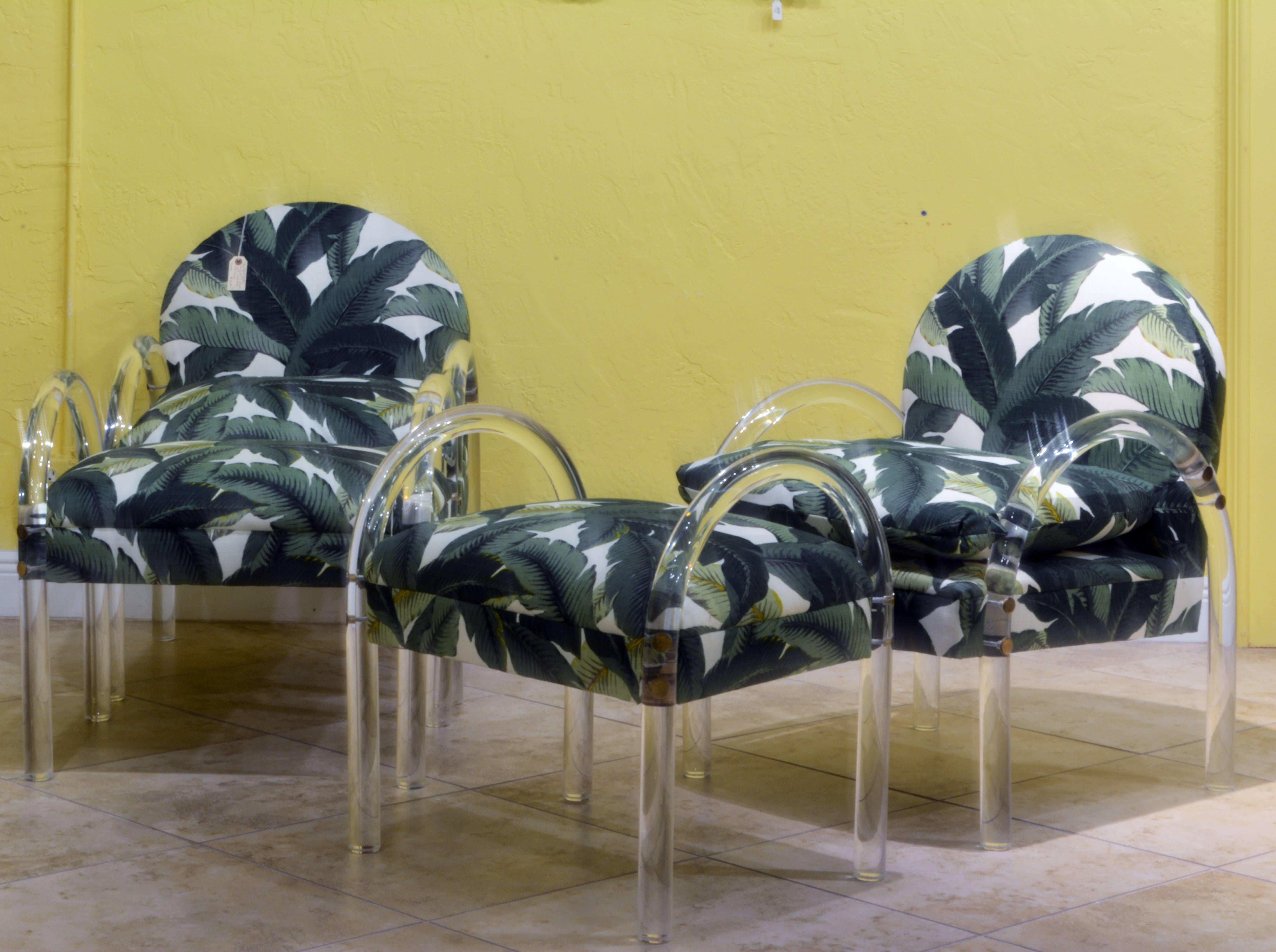 Newly covered with vibrant tropical fabric these vintage Mid-Century Modern style chairs belong to the classics of American design. The chairs measure W 25 in. D 28 in. H 35 in. Seat H 19.5 in. The ottomans measure W 25 in. D 19 in. H 26 in. Seat H