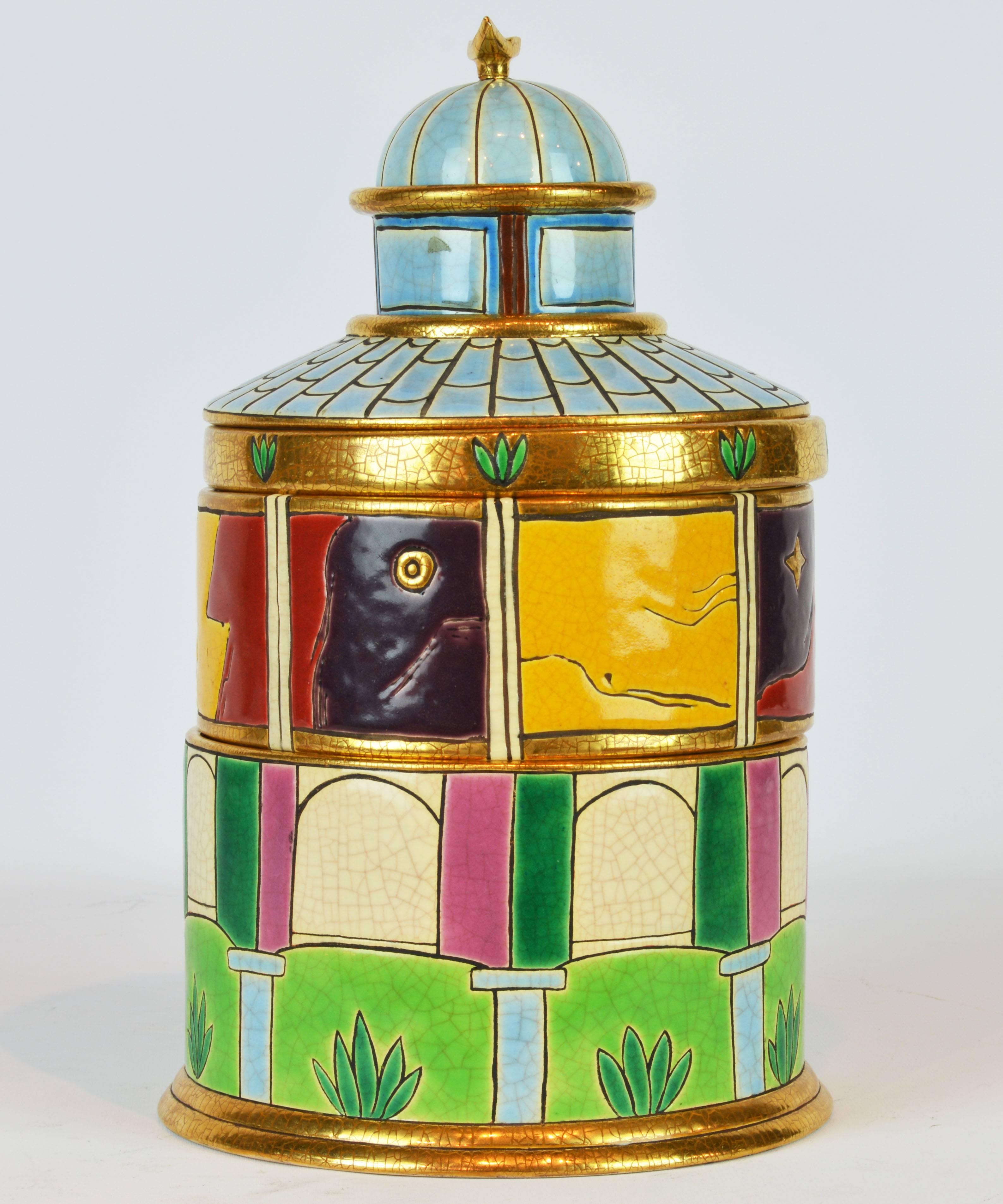 Standing 13 inches tall this is a rare and wonderful example of Pierre Casenove's designs for legendary Emaux de Longwy. View the photos to see how the tower disassembles into six single items. The faience is decorated in bright colored enamels and