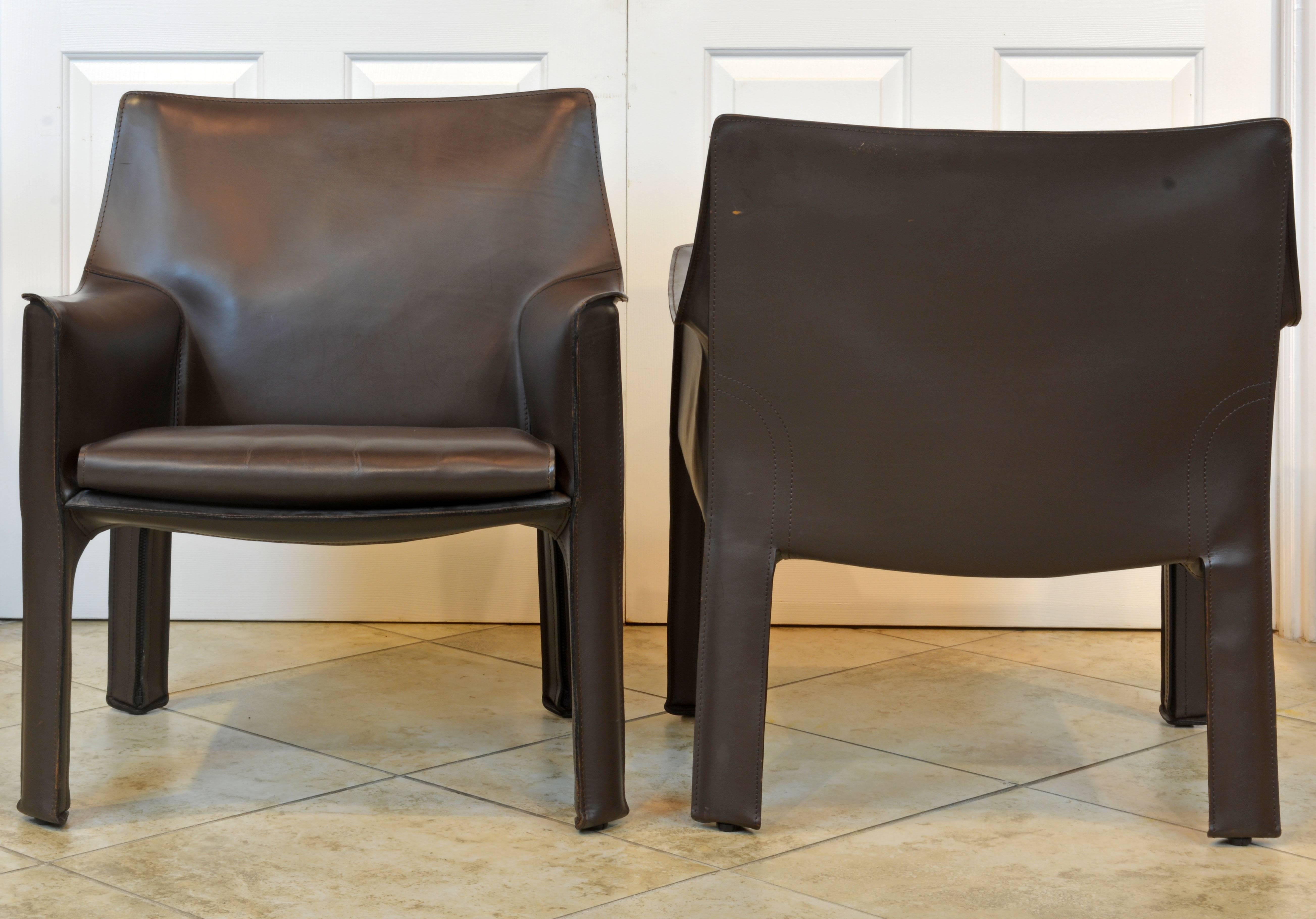 These iconic Mario Bellini leather cab lounge chairs by Cassina are constructed with a steel frame totally covered in 1st grade mocha tanned leather in good condition. The chairs are branded as shown on photos. Please note that we have a love seat