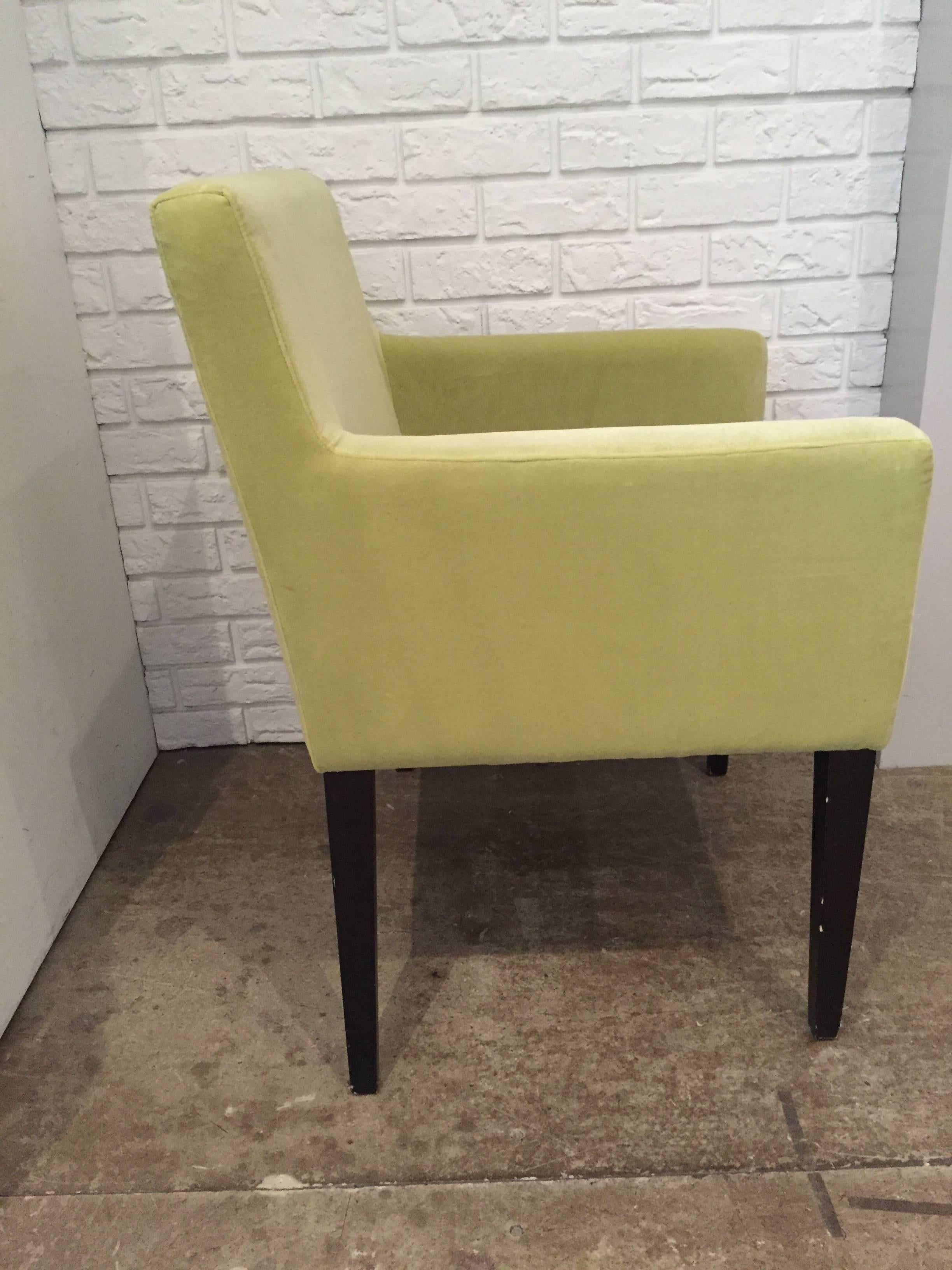 Pair of modern Dining Arm Chairs with slender wood legs. Recently reupholstered in a citrus lime Rogers and Goffigon velvet.  The chairs are versatile enough to work as occasional seating in the a Living Room or Library as well as serve as Host/ess