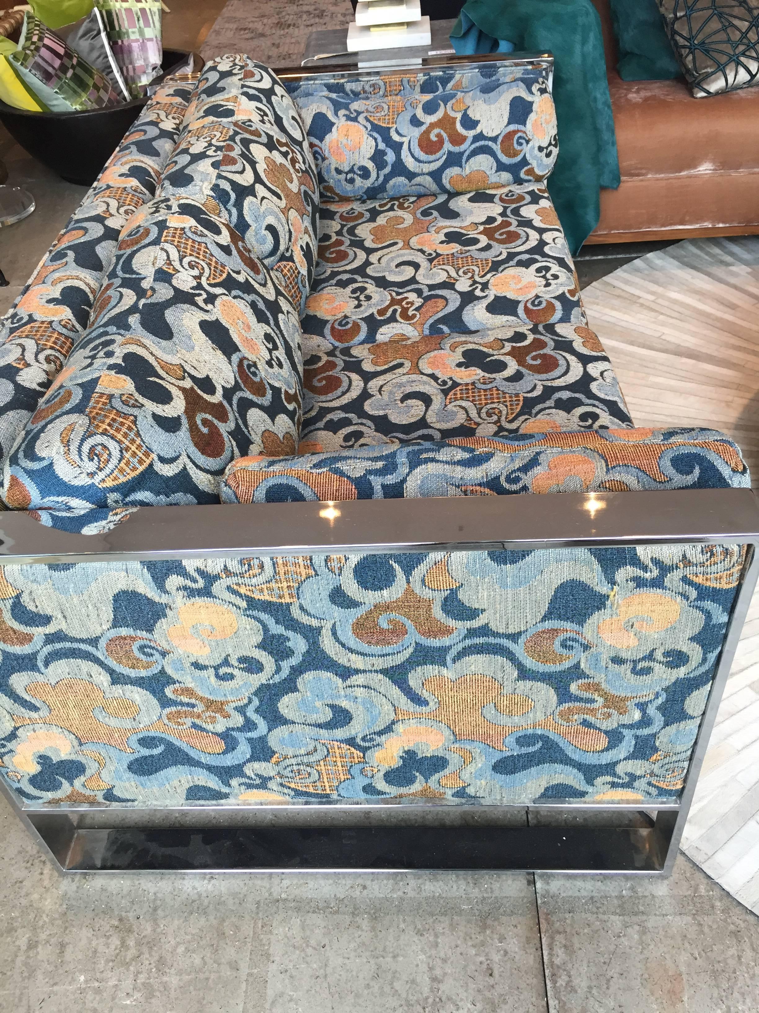 Settee with chrome frame and original upholstery (navy with grey, orange and rust abstract floral), in the style of Shawnee-Penn and Flair. 