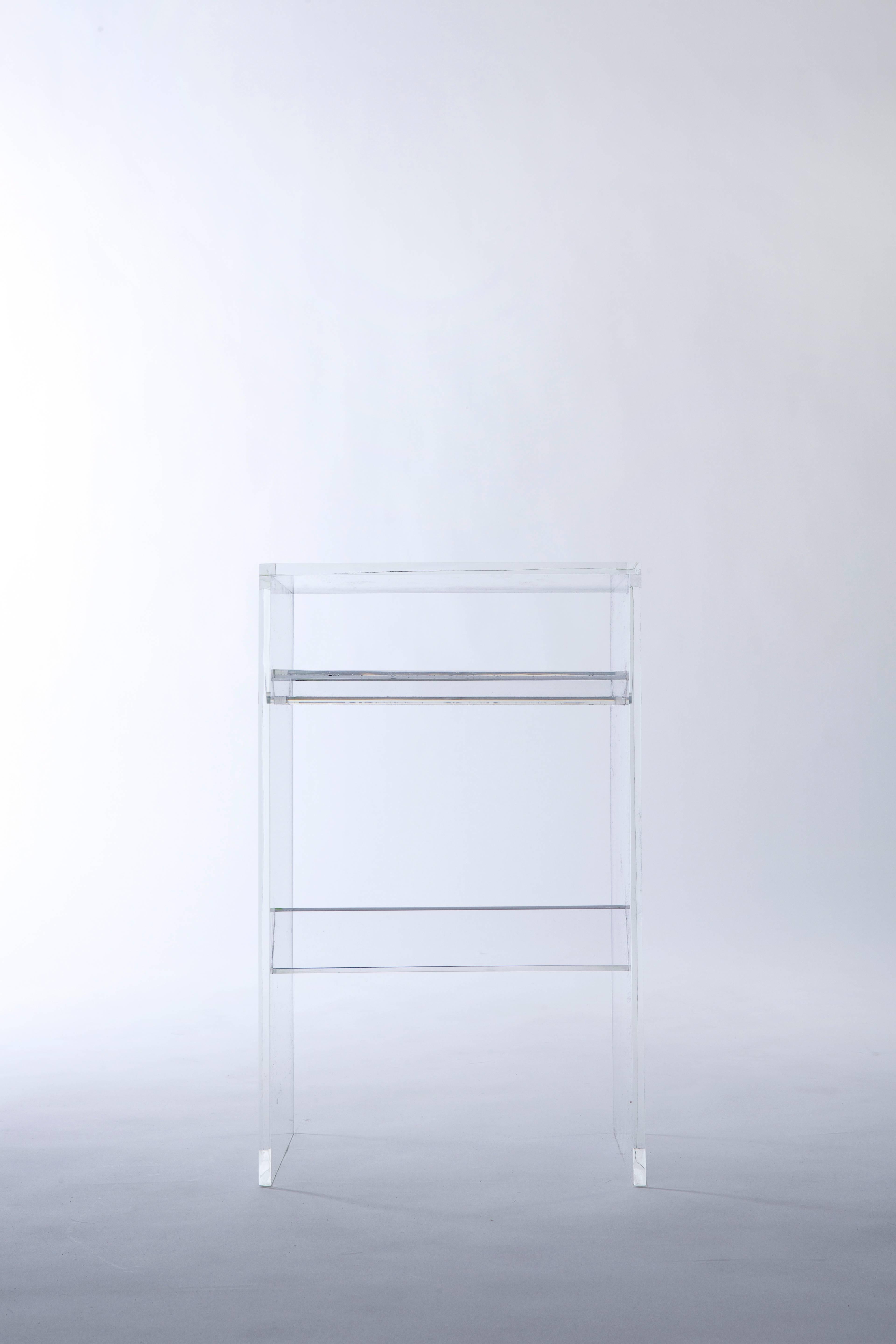 'The Stooble' is cross between a stool and a side table that is both functionally and aesthetically flexible.  

Like the other members of our 'Bond Series', the completely transparent acrylic Stooble is defined by the trough nestled underneath its