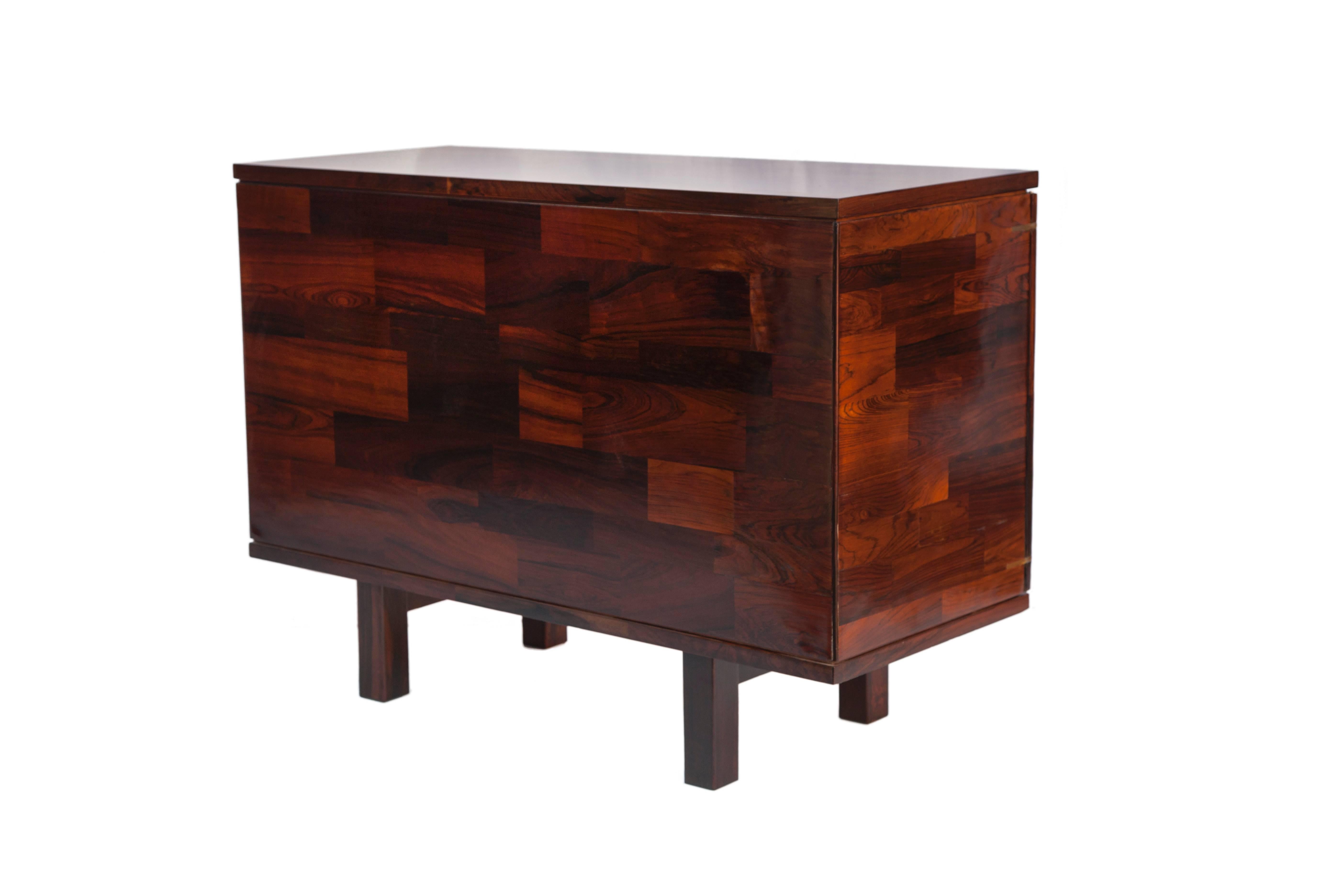 A modern rectilinear locking cabinet by Jorge Zalszupin for L'Atelier, produced circa 1960s, veneered in tiled jacaranda rosewood, the design unique to Zalszupin, with two doors, the interior with ample storage space; keys included. Very good